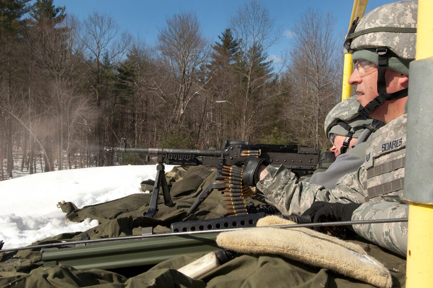 FORT DEVENS, Mass. -- (left to right) Staff Sgt. Brett Peterson and Tech.
Sgt. Philip Soares, both 157th Security Forces Squadron Combat Arms Training
and Marksmanship (CATM) personnel, fire weapons prior to a live fire
training mission on the M240B and M249 weapon systems on the range here Mar.
5. (National Guard photo by Tech. Sgt. Mark Wyatt/RELEASED)

