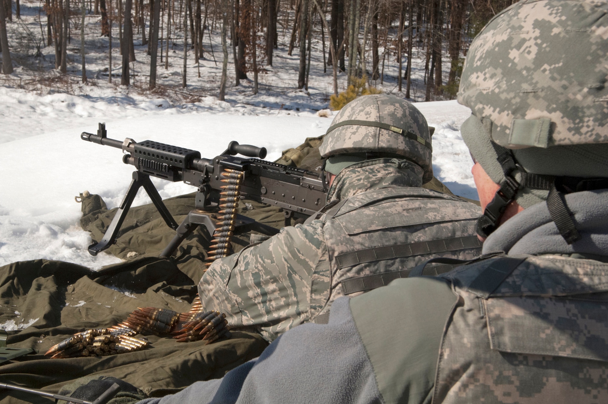 FORT DEVENS, Mass. -- (left to right) Senior Airmen Merritt Webster, 157th Security Forces Squadron, fires the M240B as Tech. Sgt. Philip Soares, a Combat Arms Training and Marksmanship instructor, observes on the range here Mar. 5.  Airmen fired the weapons on pop-up targets that provided instant feedback as well as allowed personnel to utilize their sights and engage targets at varying distances. (National Guard photo by Tech. Sgt. Mark Wyatt/RELEASED)