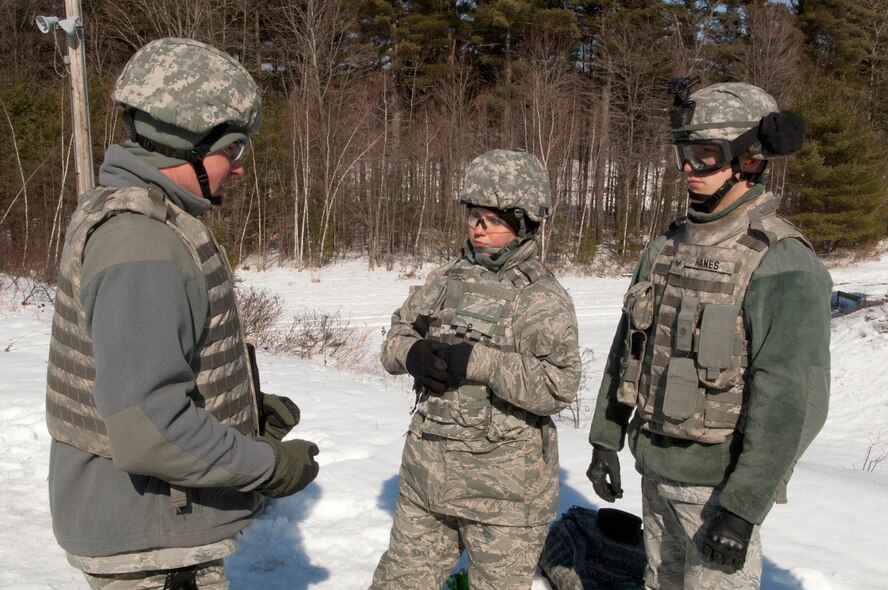 FORT DEVENS, Mass. -- (left to right) Staff Sgt. Brett Peterson, 157th
Security Forces Squadron CATM instructor, discuss range safety with Airman
1st Class Devin Godfrey and Senior Airman Michael Hanes, as they prepare for
a live fire training mission on the M240B and M249 weapon systems on the
range here Mar. 5.  Airmen fired the weapons on pop-up targets that provide
instant feedback as well as allow personnel to utilize their sights and
engage targets at varying distances. (National Guard photo by Tech. Sgt.
Mark Wyatt/RELEASED)

