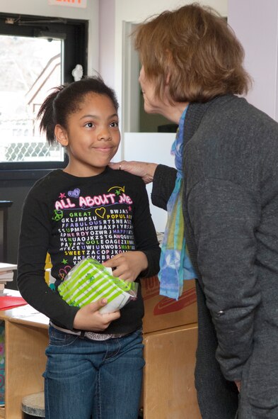 HANSCOM AIR FORCE BASE, Mass. – Ella Jackson receives a 4-H award package from Pamela LeFave, a program assistant with UMASS Northeast Regional 4-H, for her winning a Blue Danish Ribbon at the state 4-H competition last month. Ella was selected as a recipient of the Blue Danish Ribbon for her exceptional presentation skills in presenting a self-created chocolate chip sugar cookie recipe. (U.S. Air Force photo by Mark Wyatt)