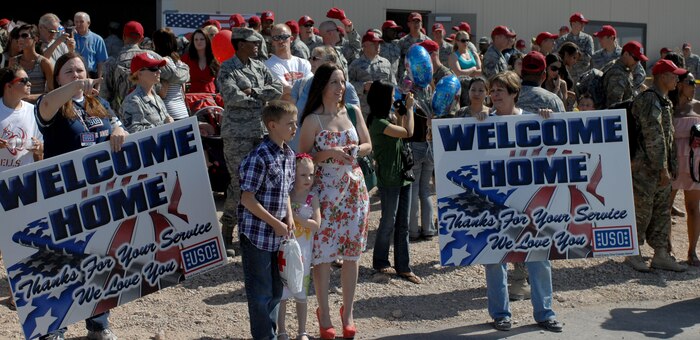 The 820th RED HORSE Squadron and family members wait for the arrival of returning RHS members during a Welcome Home ceremony April 9, 2012 at Nellis Air Force Base, Nev. Welcome Home ceremonies celebrate the reunion of deployed personal and their family members. (U.S. Air Force photo by Senior Airman Jack Sanders)