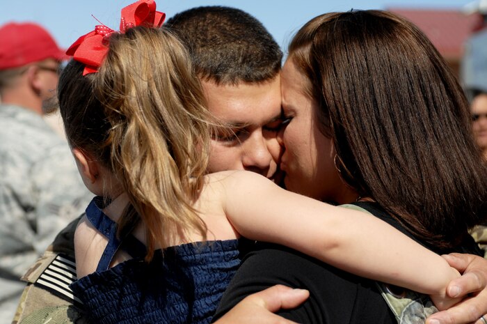 Family members celebrate during a Welcome Home ceremony April 9, 2012 at Nellis Air Force Base, Nev. 820th RED HORSE Squadron members united with their families after returning from a six-month deployment. The mission of the 820th RHS is to provide the Air Force with a highly -mobile civil engineering capability in support of contingency and special operations worldwide. (U.S. Air Force photo by Senior Airman Jack Sanders)