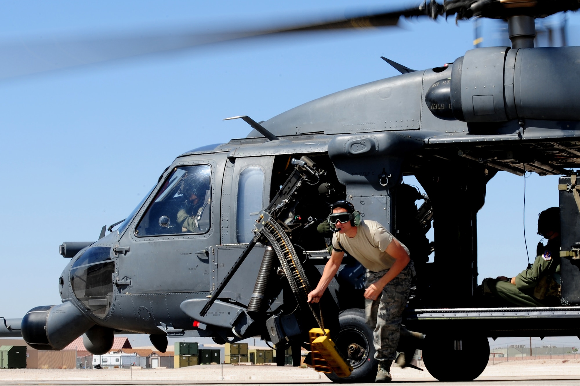 U.S. Air Force Senior Airman Michael Barnes, 763rd Maintenance Squadron crew chief, pulls the chalks during the launch of an HH-60 Pave Hawk helicopter April 9, 2012 at Nellis Air Force Base, Nev.  The 763rd Aircraft Maintenance Squadron is responsible for servicing and launch and recovery actions to maintain mission-ready status of HH-60G Pave Hawk helicopter.
(U.S. Air Force photo by Staff Sgt. William P.Coleman)
  

