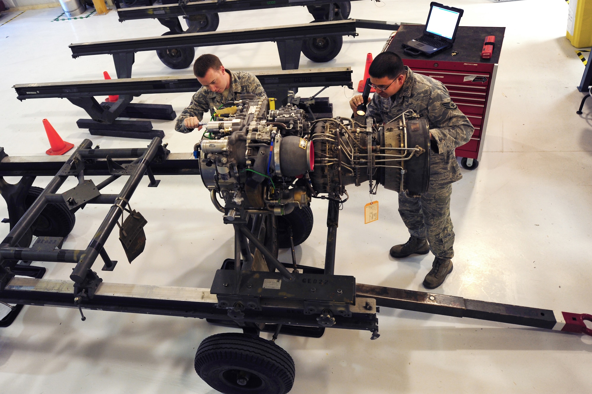 U.S. Air Force Airman 1st Class Keith Gillam and Staff Sgt. Jason Jackson, 763rd Maintenance Squadron aerospace propulsion technicians, conduct a scheduled tear down and buildup of an T701C helicopter engine April 9, 2012 at Nellis Air Force Base, Nev.  The 763rd Maintenance Squadron plans, schedules and directs both scheduled and unscheduled preventative maintenance to maintain mission-ready status.  (U.S. Air Force photo by Staff Sgt. William P.Coleman)
  

