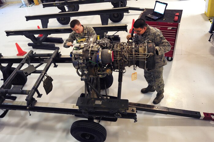 U.S. Air Force Airman 1st Class Keith Gillam and Staff Sgt. Jason Jackson, 763rd Maintenance Squadron aerospace propulsion technicians, conduct a scheduled tear down and buildup of an T701C helicopter engine April 9, 2012 at Nellis Air Force Base, Nev.  The 763rd Maintenance Squadron plans, schedules and directs both scheduled and unscheduled preventative maintenance to maintain mission-ready status.  (U.S. Air Force photo by Staff Sgt. William P.Coleman)  