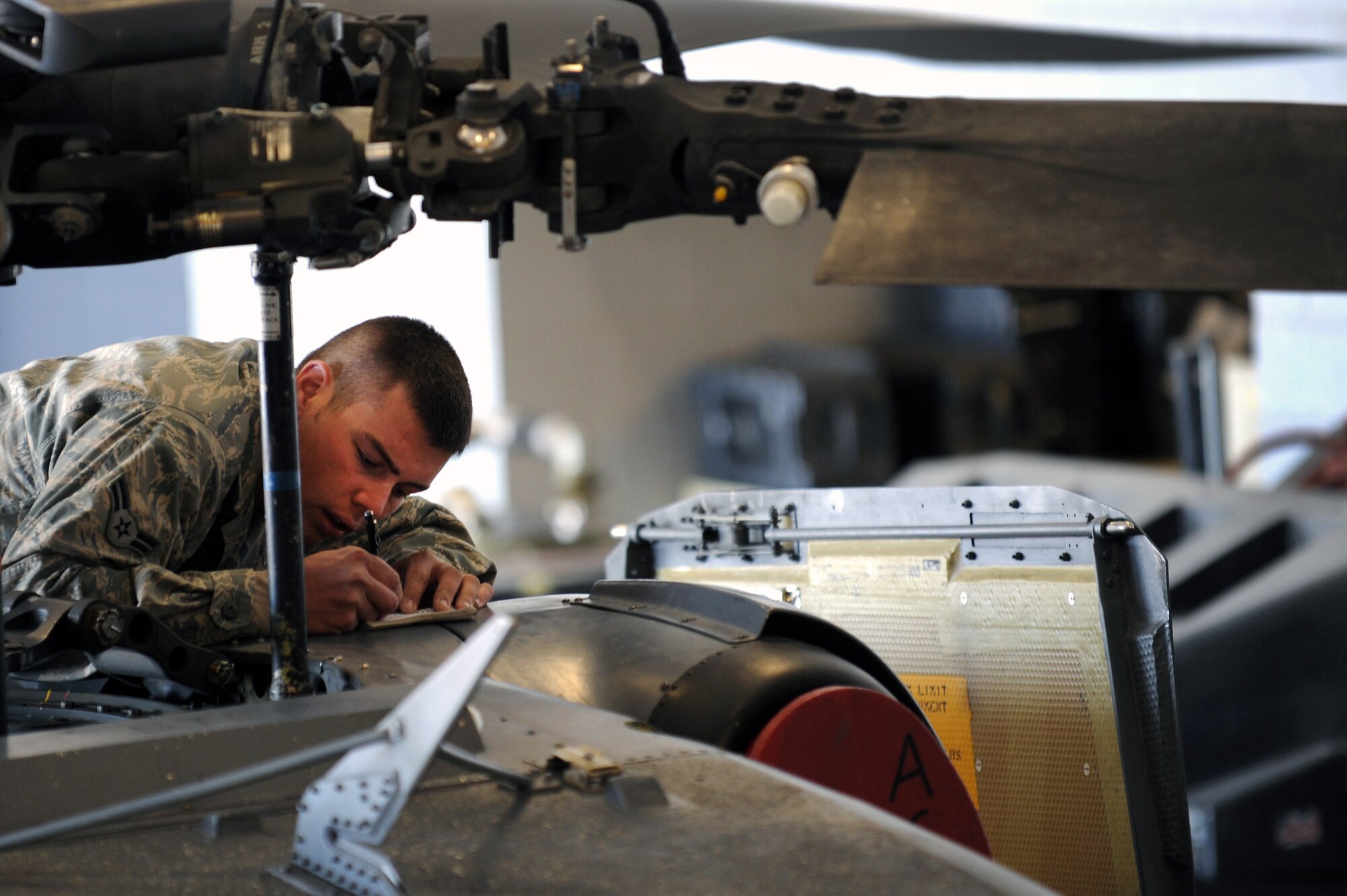 U.S. Air Force Airman 1st Class Robert Wainwright, 763rd Maintenance Squadron crew chief, documents the operating hours of  an HH-60 Pave Hawk helicopter engine April 6, 2012 at Nellis Air Force Base, Nev.  The 763rd Maintenance Squadron plans, schedules and directs both scheduled and unscheduled preventative maintenance to maintain mission-ready status.  (U.S. Air Force photo by Staff Sgt. William P.Coleman)
  

