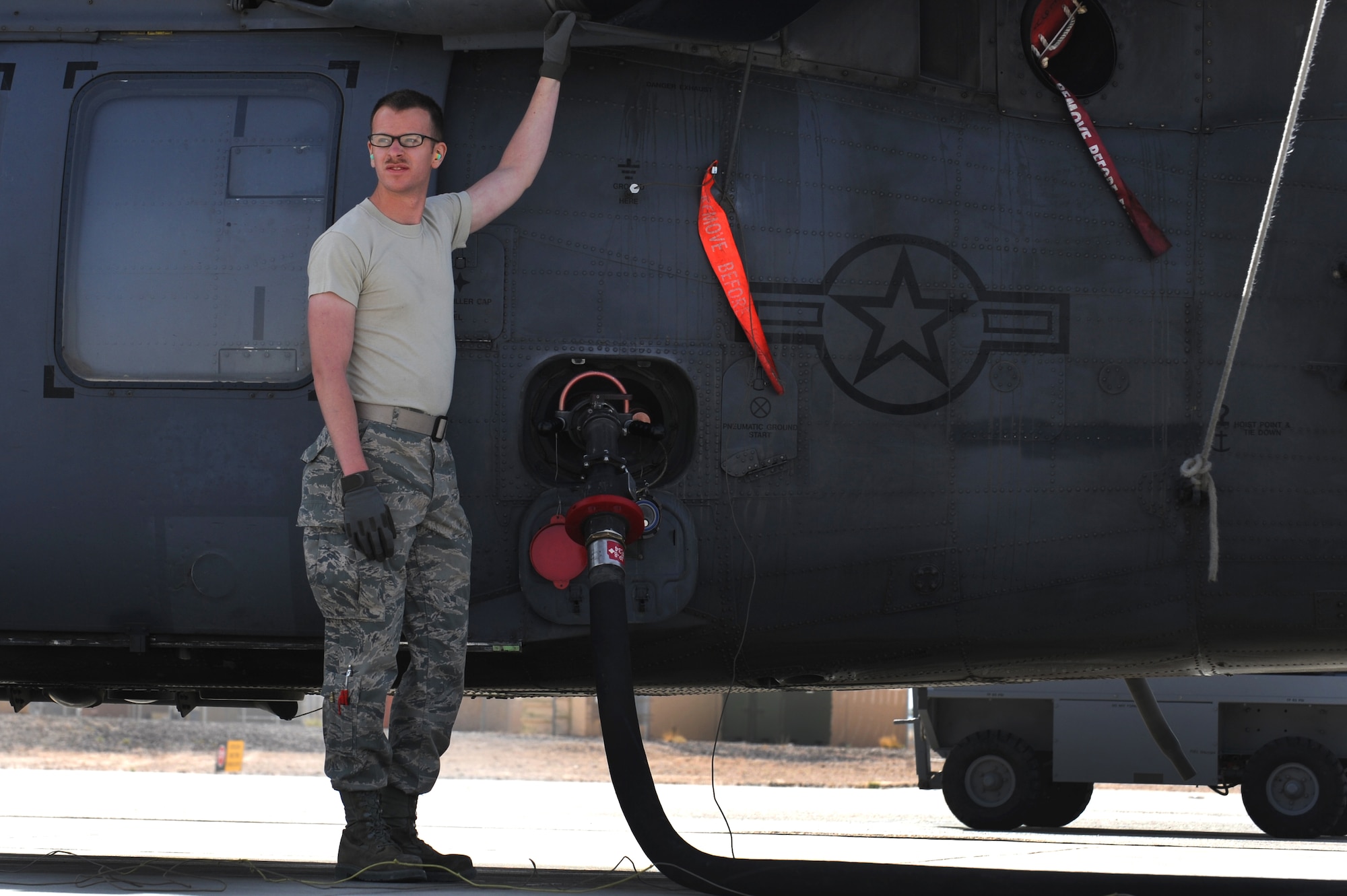 U.S. Air Force Airman 1st Class Matthew Thompson, 763rd Maintenance Squadron electronic counter measurements journeyman, fuels an HH-60 Pave Hawk helicopter April 5, 2012 at Nellis Air Force Base, Nev.  The 763rd Maintenance Squadron is assigned to the 23rd Maintenance Group at Moody Air Force Base, GA.  (U.S. Air Force photo by Staff Sgt. William P.Coleman)
  

