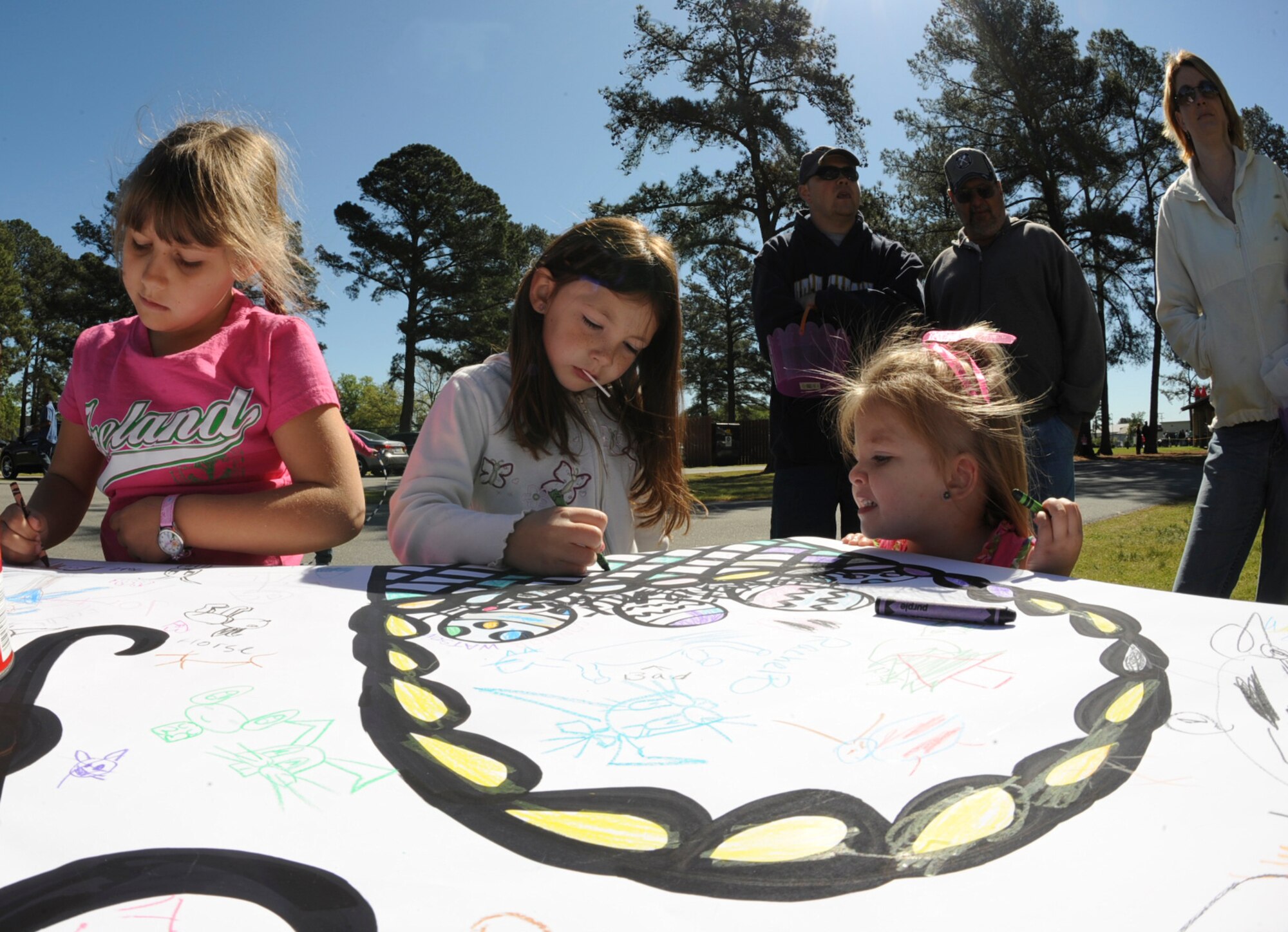Children color a banner during an Easter Egg Hunt at Debden Park on Seymour Johnson Air Force Base, N.C., April 7, 2012. There were a number of activities including coloring and volleyball for the children to participate in as they waited for their chance to hunt for Easter eggs. The event was hosted by the 4th Force Support Squadron. (U.S. Air Force photo/Airman 1st Class Aubrey Robinson/Released)