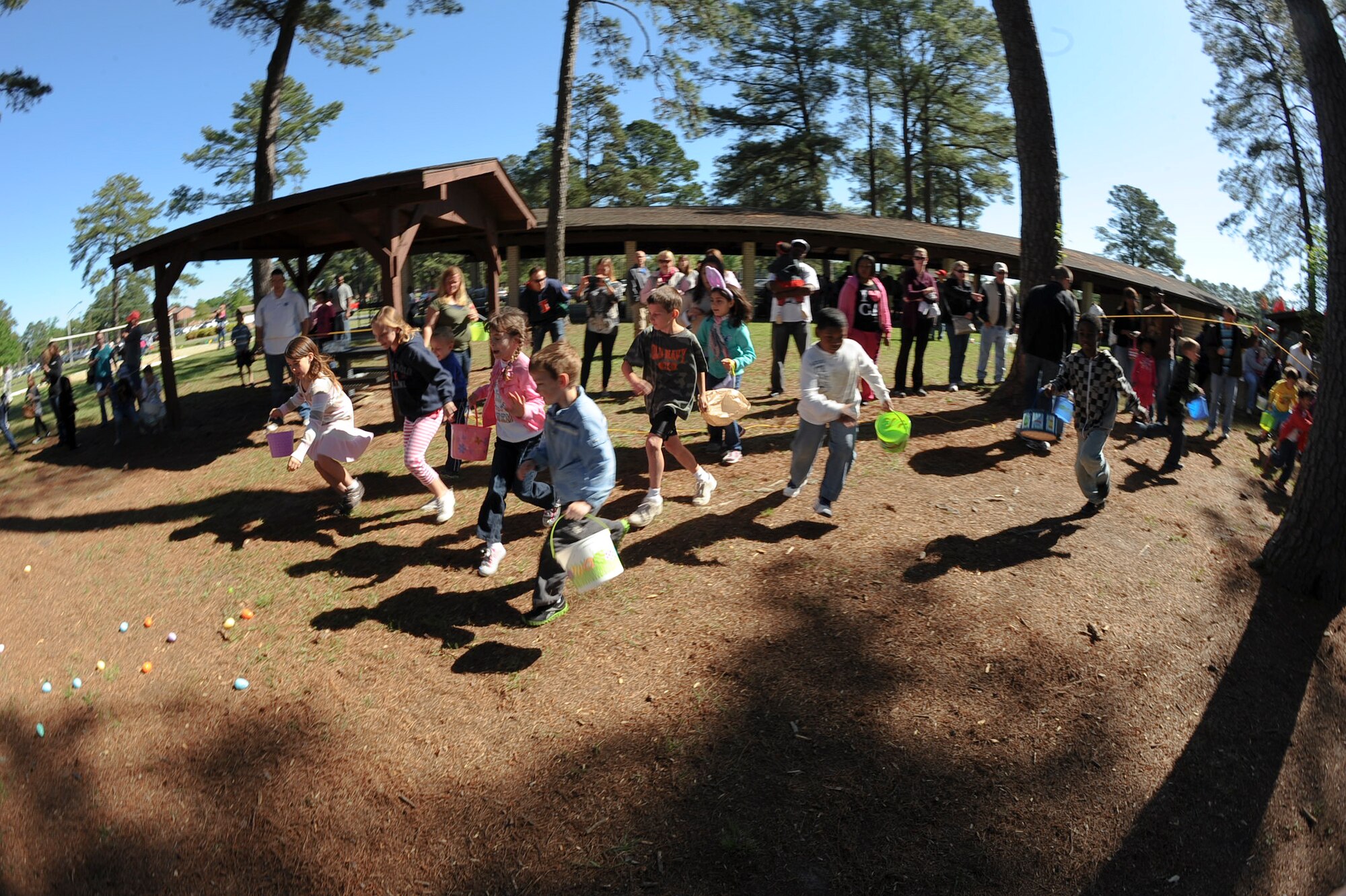 Children of 4th Fighter Wing Airmen hurry to gather eggs during an Easter Egg Hunt at Debden Park on Seymour Johnson Air Force Base, N.C., April 7, 2012. The children had to spell “Easter” using letters written on the eggs in order to exchange for treats. (U.S. Air Force photo/Airman 1st Class Aubrey Robinson/Released)