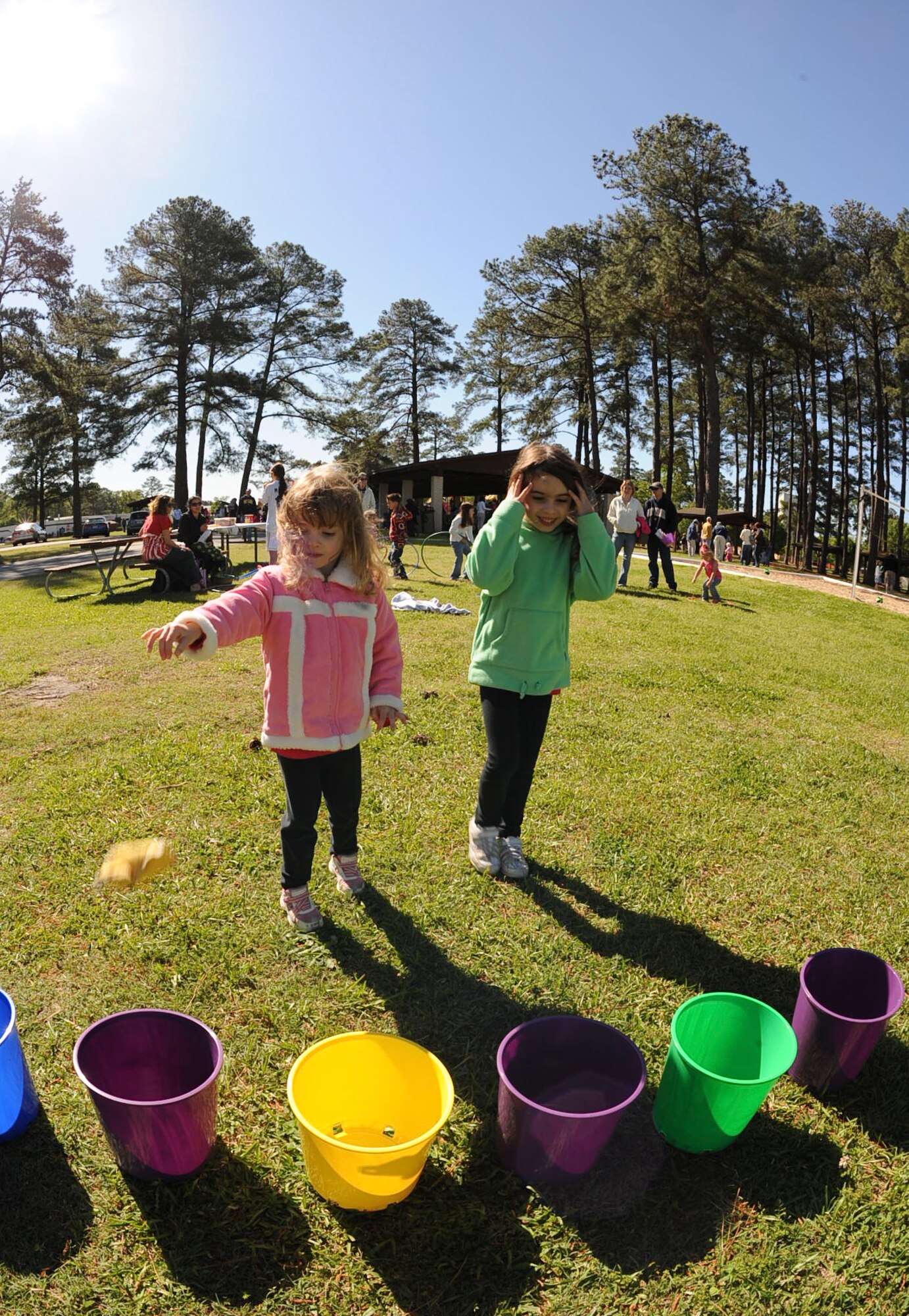 Kaybren Wiest, 6, watches as her sister, Karsyn, 3, tosses a bean bag at Debden Park on Seymour Johnson Air Force Base, N.C., April 7, 2012. The sisters took turns playing the game after participating in an Easter Egg Hunt hosted by the 4th Force Support Squadron. Karsyn and Kaybren are the daughters of Master Sgt. William Wiest, 4th Logistics Readiness Squadron quality assurance manager, and hail from Goldsboro, N.C. (U.S. Air Force photo/Airman 1st Class Aubrey Robinson/Released)