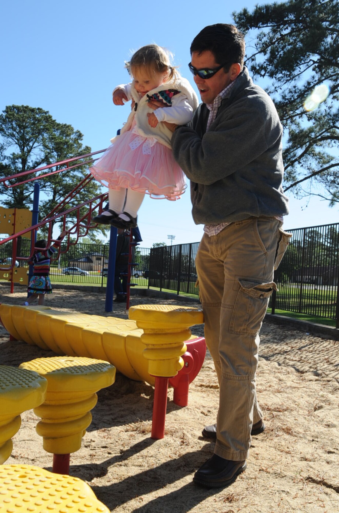 Keven Gambold plays with his daughter, Abigail, 7 months, at Debden Park on Seymour Johnson Air Force Base, N.C., April 7, 2012. The Gambolds took time away from the base Easter Egg Hunt to release some extra energy at the park. Keven and Abigail are the husband and daughter of U.S. Air Force Maj. Catherine Gambold, 4th Operations Support Squadron chief of wing intelligence. Keven hails from York, England. (U.S. Air Force photo/Airman 1st Class Aubrey Robinson/Released)