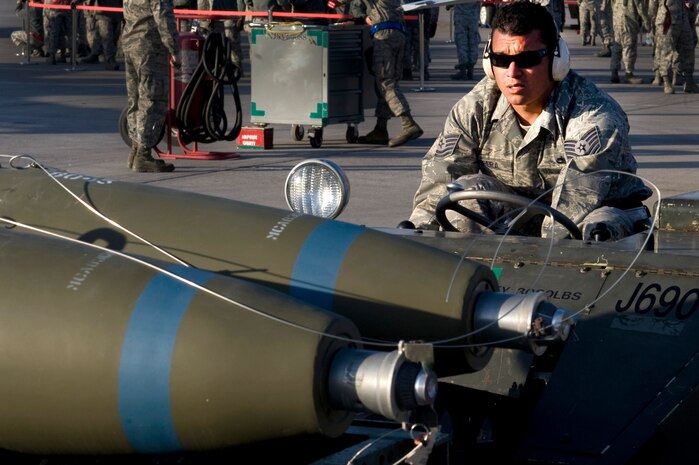 U.S. Air Force Tech. Sgt Michael Perera, 926th Aircraft Maintenance Squadron weapons loader, prepares to load a MK-82 general purpose bomb during the quarterly weapons load competition, April 6 2012, at Nellis Air Force Base, Nev. The load crew competition audience is comprised of commanders, supervisors, fellow Airmen and family members. (U.S. Air Force photo by Airman 1st Class Matthew Lancaster)