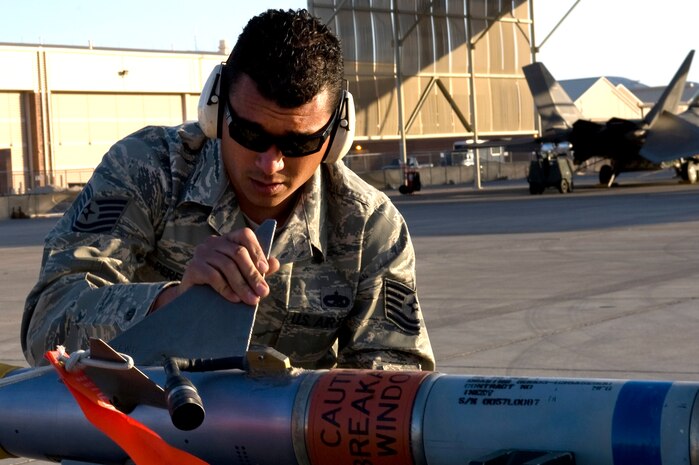 U.S. Air Force Tech. Sgt. Michael Perera, 926th Aircraft Maintenance Squadron weapons loader, inspects an AIM-9M Sidewinder missile during the quarterly weapons load competition, April 6 2012, at Nellis Air Force Base, Nev. The load crew competition gives the crews an opportunity to display their skills to the wing. (U.S. Air Force photo by Airman 1st Class Matthew Lancaster)