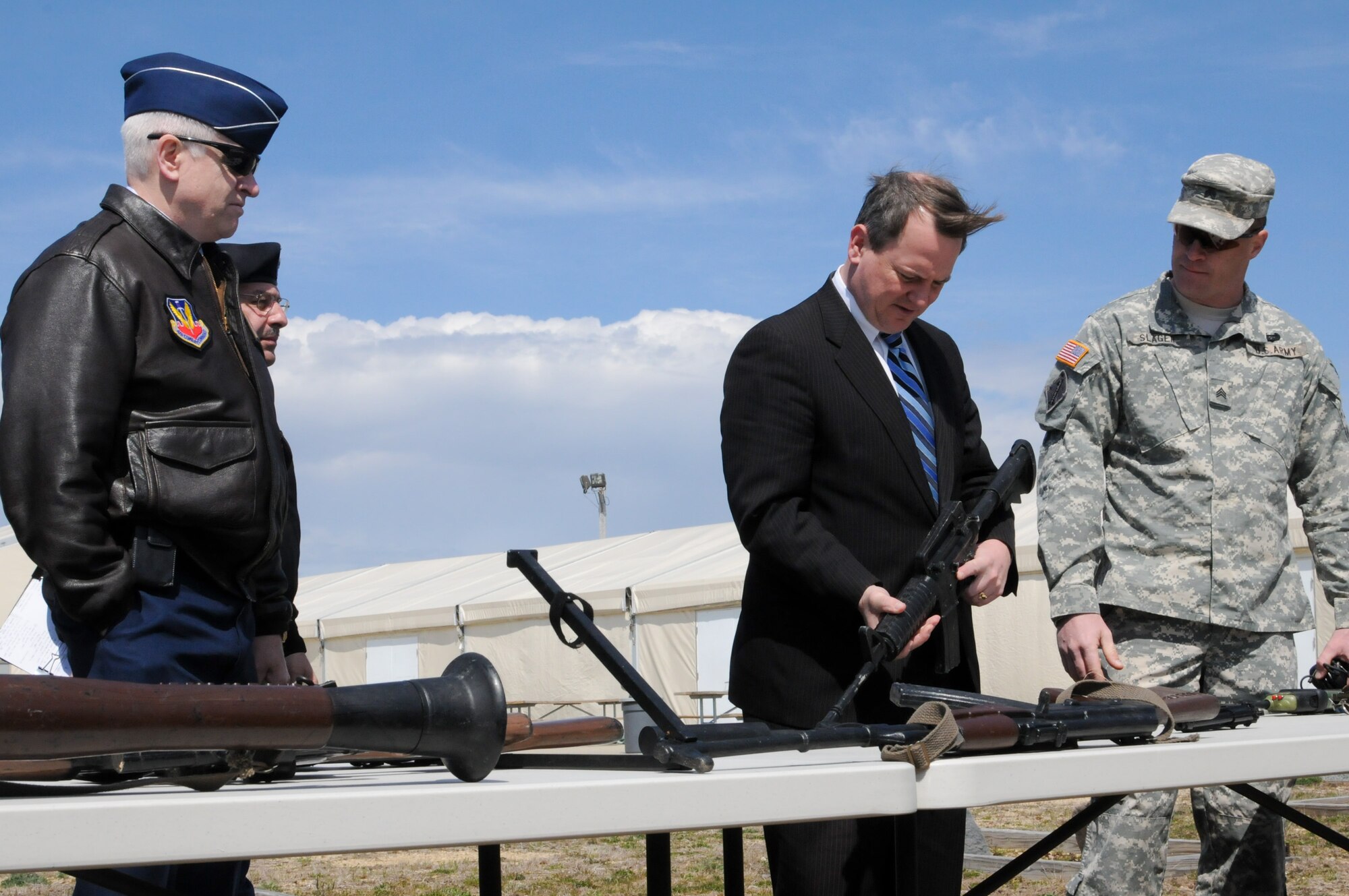 Massachusetts Lt. Gov. Timothy Murray and acting Adjutant General of the Massachusetts National Guard Maj. Gen. L. Scott Rice observe various weapons on display with Sgt. John Slager, Camp Edwards training manager, during a tour of the Massachusetts Military Reservation, April 9.  Murray is currently touring military installations across Massachusetts with members of the state’s Military Asset and Security Strategy Task Force in support of protecting the missions, jobs and economic investments associated with the bases. (Air National Guard photo by Tech. Sgt. Kerri Cole/Released)