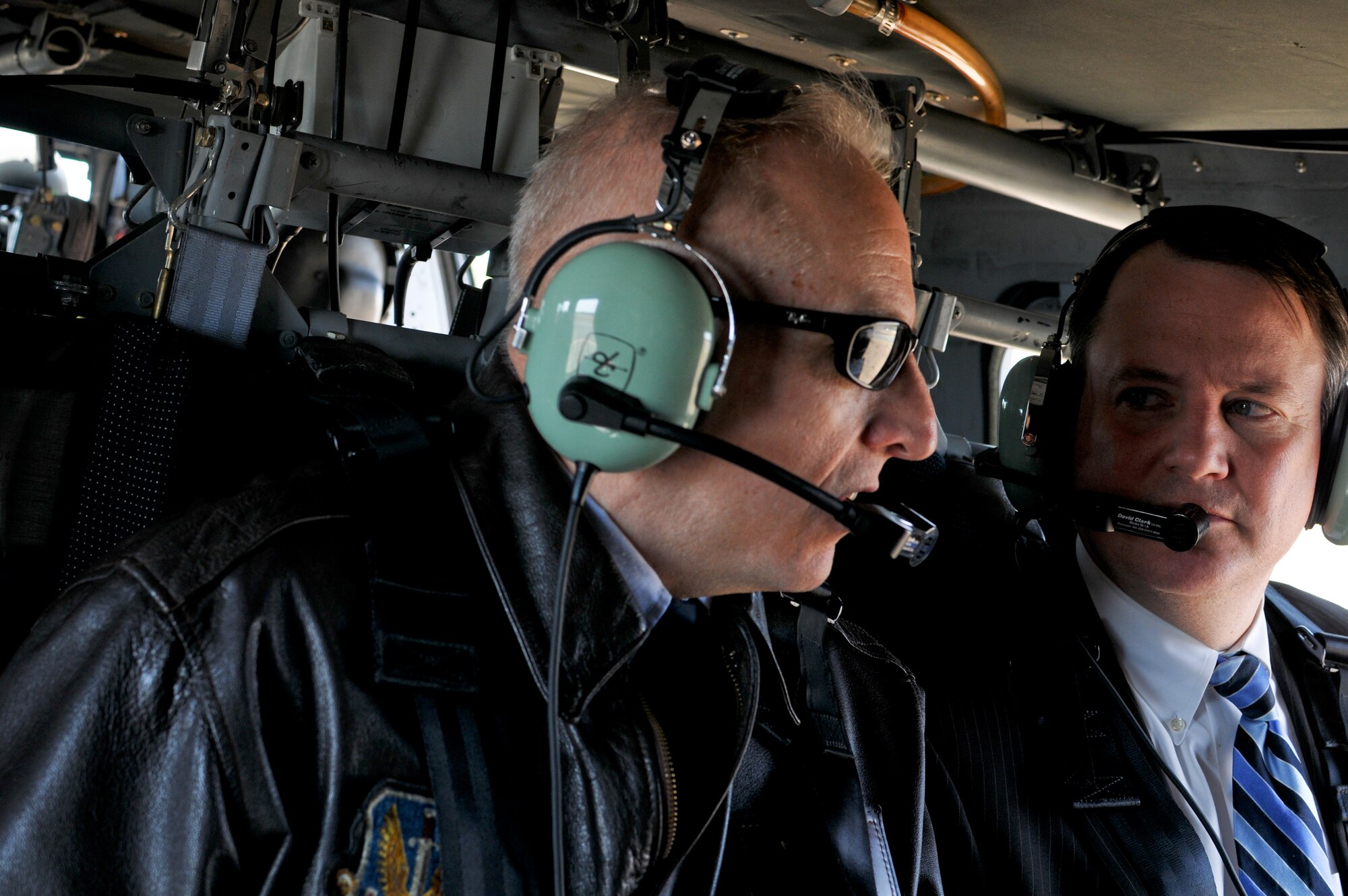 Massachusetts Lt. Gov. Timothy Murray listens to a briefing from Col. Anthony Schiavi, 102nd Intelligence Wing commander, in a U.S. Army UH-60 Blackhawk during an aerial tour of the Massachusetts Military Reservation, April 9.  Murray is currently touring military installations across Massachusetts with members of the state’s Military Asset and Security Strategy Task Force in support of protecting the missions, jobs and economic investments associated with the bases. (Air National Guard photo by Tech. Sgt. Kerri Cole/Released)