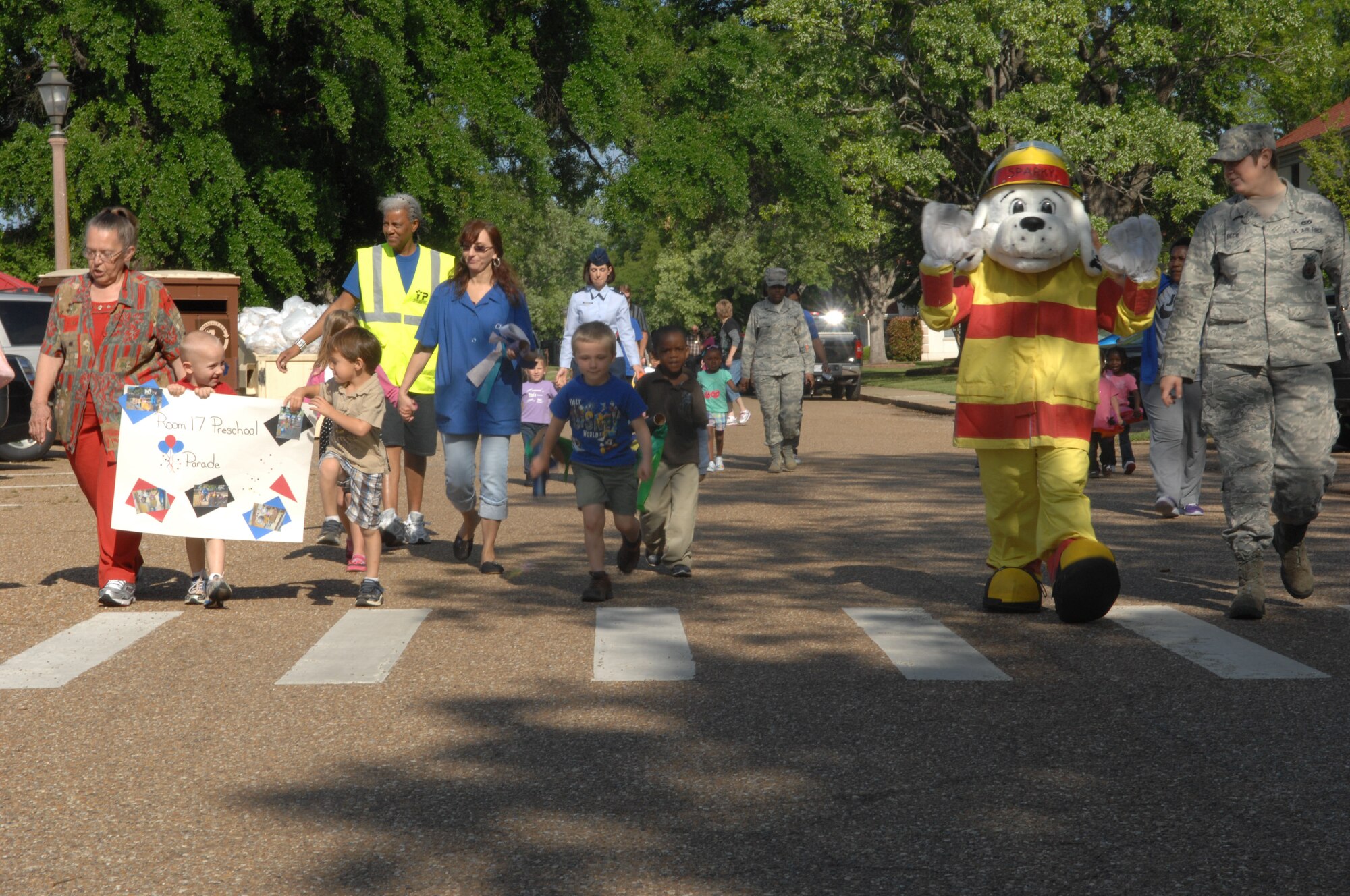 Parents join their children and Child Development Center providers in a parade to celebrate the National Month of the Military Child on Barksdale Air Force Base, La., April 5. The children had fun singing and playing alongside Sparky the Fire Dog. This special celebration is a legacy of former Defense Secretary Caspar Weinberger and was established to underscore the important role children play in the armed forces community. April is packed with special activities sponsored by the CDC to acknowledge the unique contributions military children make. (U.S. Air Force photo/Airman 1st Class Joseph A. Pagán JR.)(RELEASED) 