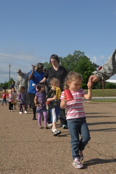 Parents join their children and Child Development Center providers for a parade around Barksdale Air Force Base, La., April 5. The parade was held in support of the National Month of the Military Child. The children had fun singing and playing with their parents and providers as a fire truck led the way. (U.S. Air Force photo/Airman 1st Class Joseph A. Pagán Jr.)(RELEASED)