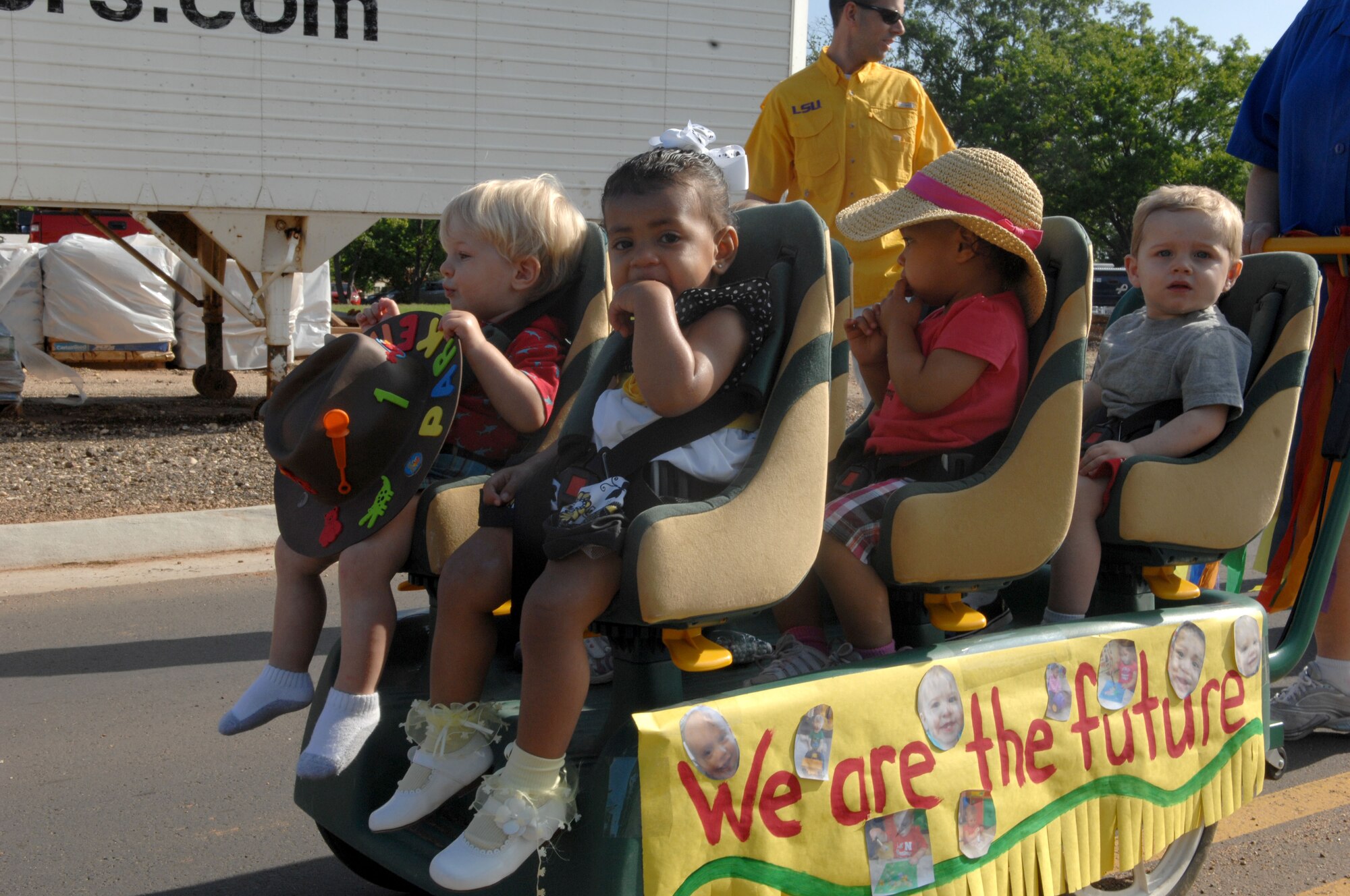 Children of the Child Development Center participate in a parade celebrating the National Month of the Military Child on Barksdale Air Force Base, La., April 5. Children were accompanied by their parents and CDC providers while being pushed around the base. April is designated as the Month of the Military Child to celebrate the unique contributions, commitment, and sacrifices military children make on behalf of our country. (U.S. Air Force photo/Airman 1st Class Joseph A. Pagán Jr.)(RELEASED)