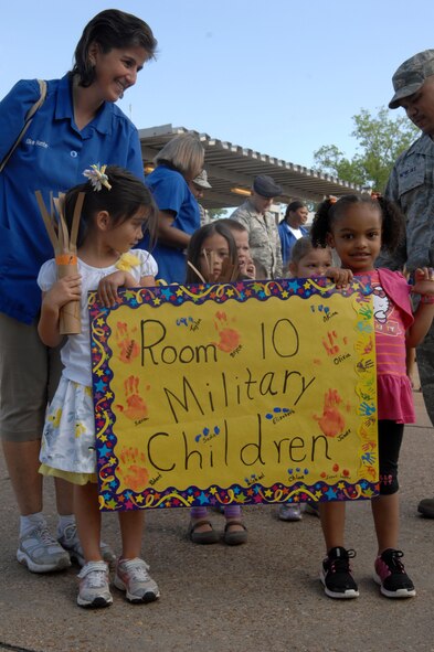 Parents join their children and Child Development Center providers for a parade around Barksdale Air Force Base, La., April 5. The parade was held in support of the National Month of the Military Child. (U.S. Air Force photo/Airman 1st Class Joseph A. Pagán Jr.)(RELEASED)