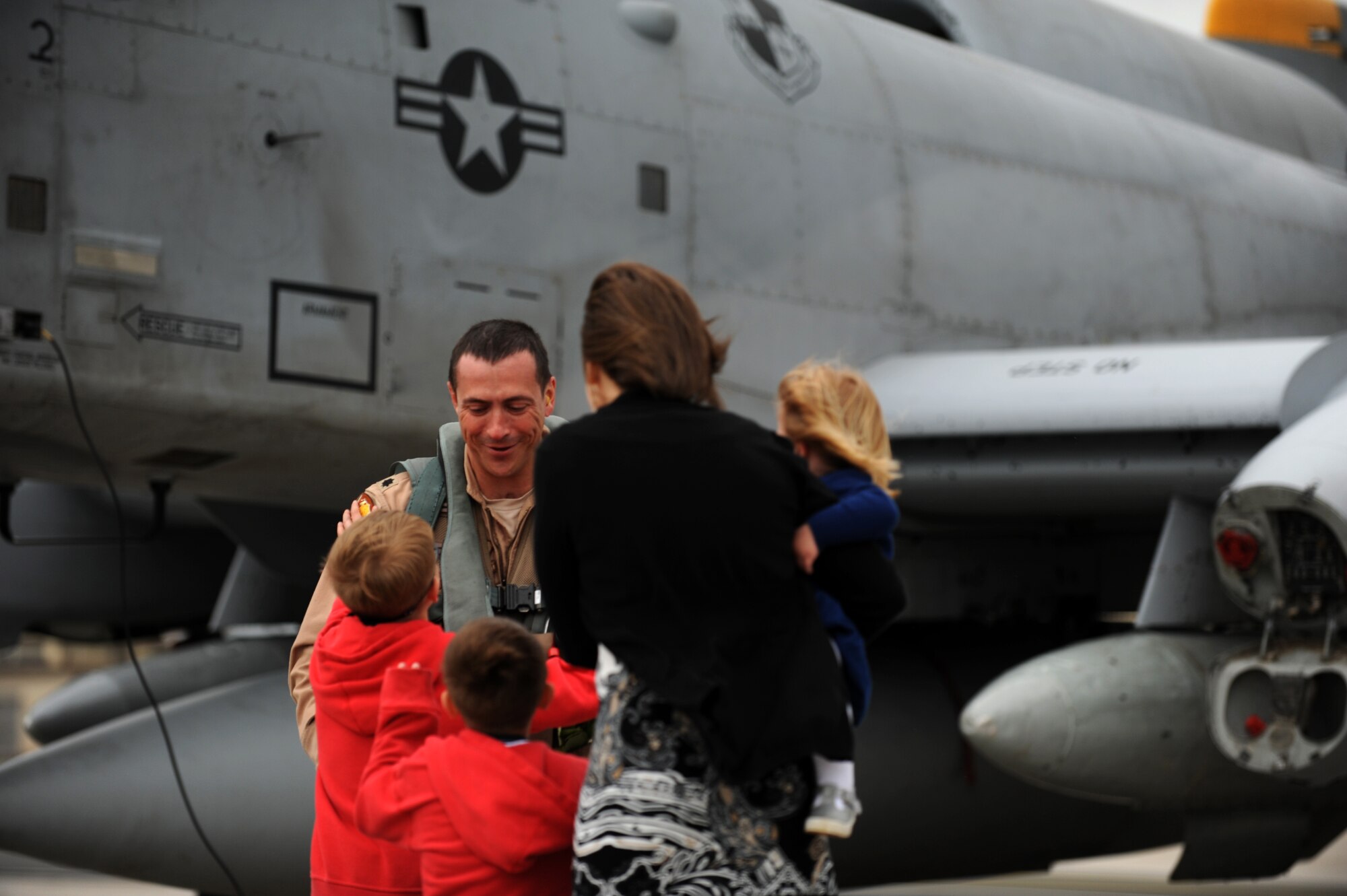 SPANGDAHLEM AIR BASE, Germany – Lt. Col. Joshua Ruddell, 81st Fighter Squadron pilot and director of operations, is welcomed home by his wife, Neva, and children, from left, Tyler, Carter and Bella on Ramp 4 here April 10 after returning from his deployment from Bagram Airfield, Afghanistan. Ruddell was one of the squadron’s six pilots who had been providing close air support during Operation Enduring Freedom. (U.S. Air Force photo by Airman 1st Class Matthew B. Fredericks/Released)