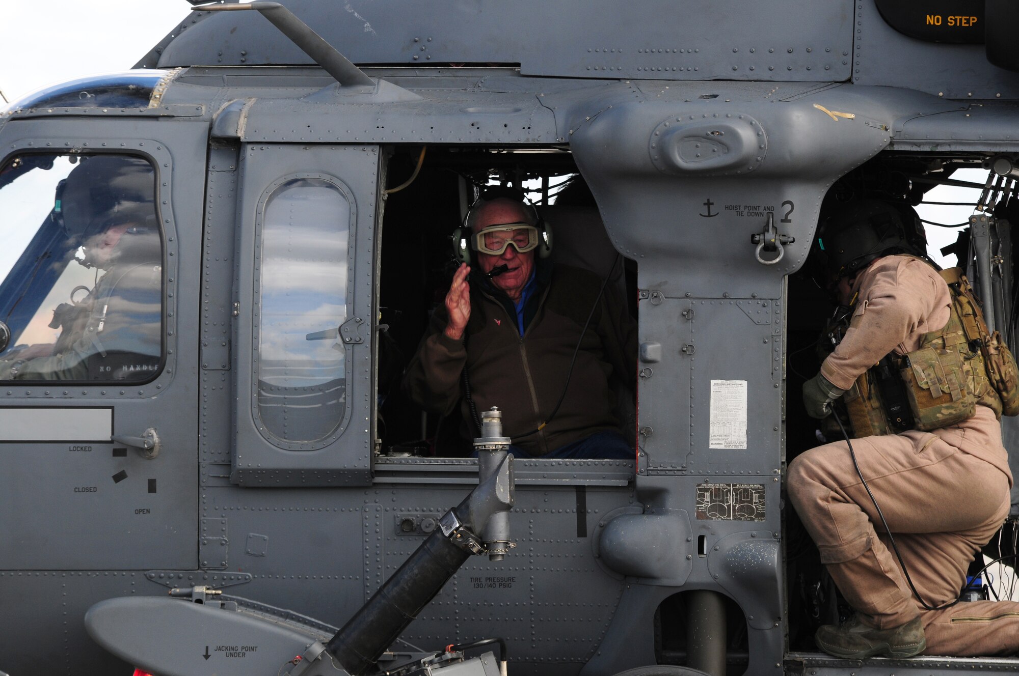 ROYAL AIR FORCE LAKENHEATH, England – Ret. Brig. Gen. Charles E. “Chuck” Yeager, waves to friends and family before taking off in an HH-60G Pave Hawk helicopter April 10, 2012.  Yeager visited the Liberty Wing to talk to Airmen about his Air Force career and experiences. (U.S. Air Force photo by Airman 1st Class Cory D. Payne)