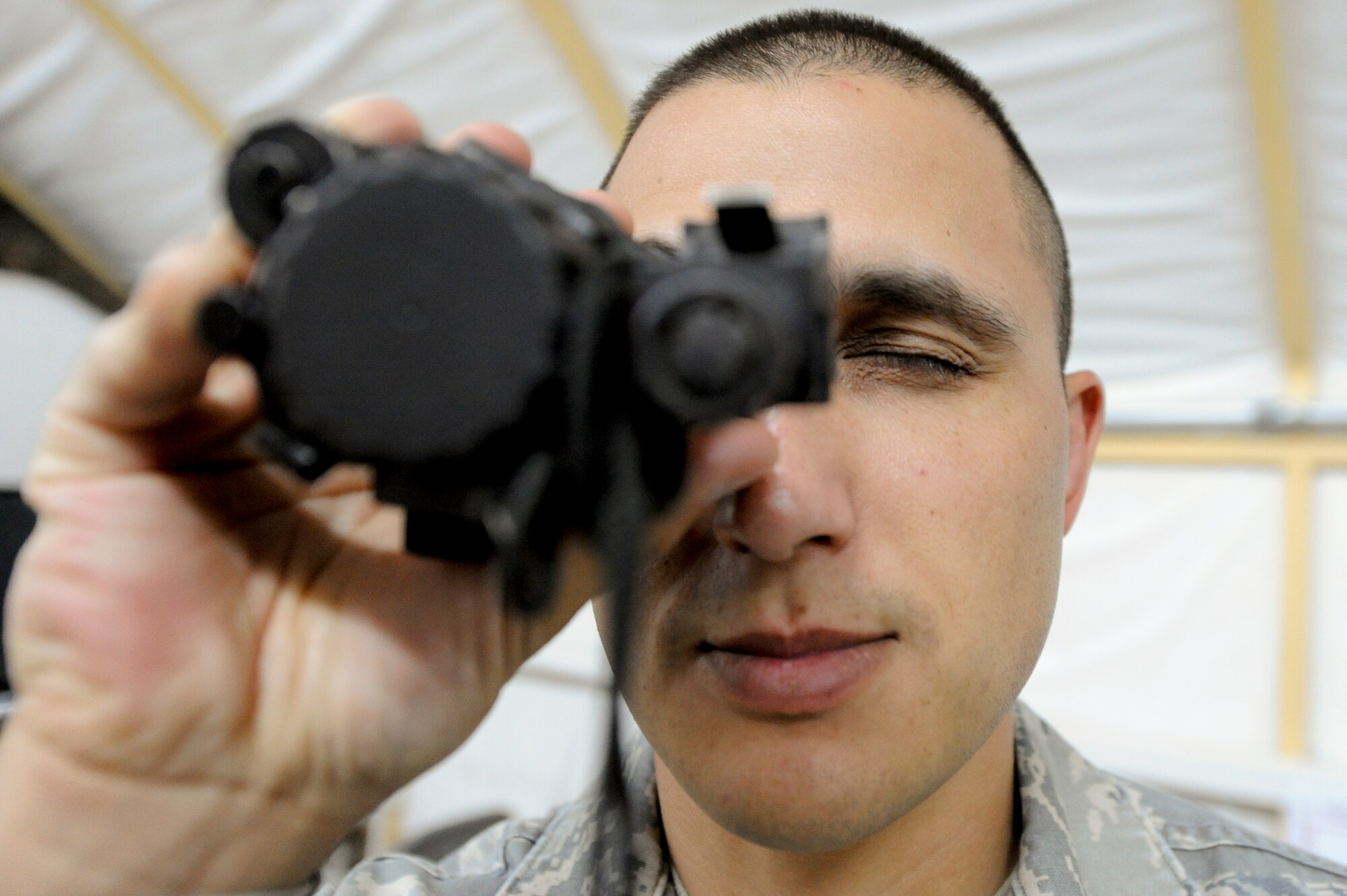 CAMP BUEHRING, KUWAIT -- Tech. Sgt. Timothy Sands, 332nd Air Expeditionary Wing ground safety NCO, looks through a PVS-14, monocular night vision goggle, here, April 10, 2012. The PVS-14 is used by Air Force Tactical Air Control Party members. Sands is deployed from Kirtland Air Force Base, N.M. and is a native of Albuquerque, N.M. (U.S. Air Force photo by Staff Sgt. Joshua J. Garcia)