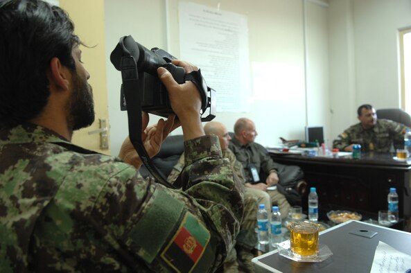 Afghan air force Master Sgt. Mir Mazhar shoots video of Afghan air force Command Sgt. Maj. Hakim Waziry during a meeting of enlisted leaders April 4-5 at Kandahar Airfield, Afghanistan. Mir was taking part in his first ever news trip. (U.S. Air Force photo by Tech. Sgt. Jeremy Larlee)
