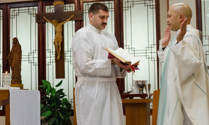 On the right, Chaplain (Capt.) Dennis DeGuzman, 8th Fighter Wing priest, reads the opening prayer during the Easter vigil, April 7, 2012, at Kunsan Air Base, Republic of Korea. The vigil is held on Holy Saturday and represents the beginning of the Easter season. (U.S. Air Force photo/Senior Airman Derrick Schwieters)