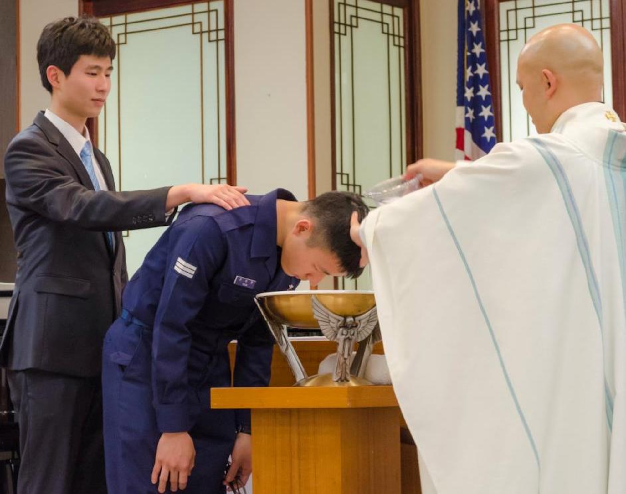 A Republic of Korea Air Force member is baptized during the Catholic Easter Vigil Mass at the base chapel, April 7, 2012, on Kunsan Air Base, Republic of Korea. Once baptized, he was officially considered a member of the Catholic Church. (U.S. Air Force photo/Senior Airman Derrick Schwieters)