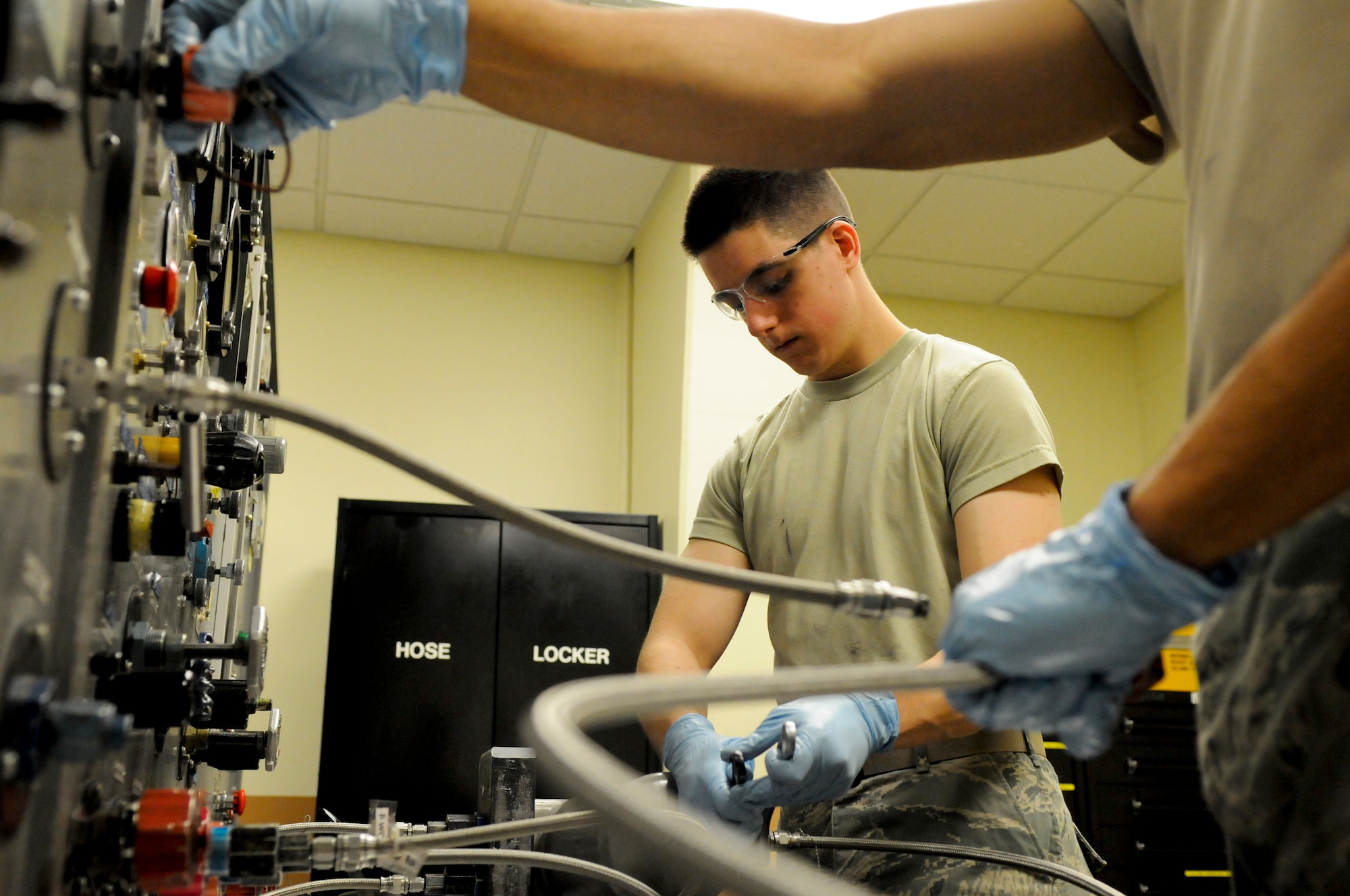 U.S. Air Force Airman 1st Class James Ruggiero, 18th Component Maintenance Squadron hydraulic aircraft systems journeyman, bench tests a jet fuel starter accumulator to ensure it functions properly before installing it in an aircraft on Kadena Air Base, Japan, April 5, 2012. The 18th CMS maintains the brakes, struts and any other hydraulic systems in need of repair or service. (U.S. Air Force photo by Airman 1st Class Tara A. Williamson/Released)
