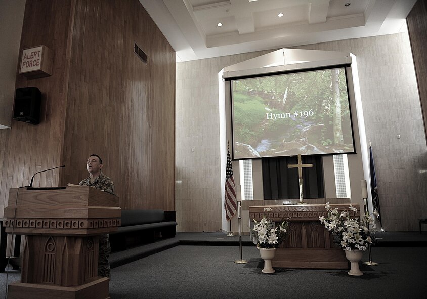 U.S. Air Force Chaplain (Capt.) Kevin Humphrey sings a hymn while leading a church service on Kadena Air Base, April 3, 2012. Humphrey helped evacuate a hospital during his recent deployment. (U.S. Air Force photo by Airman 1st Class Brooke P. Beers/Released)