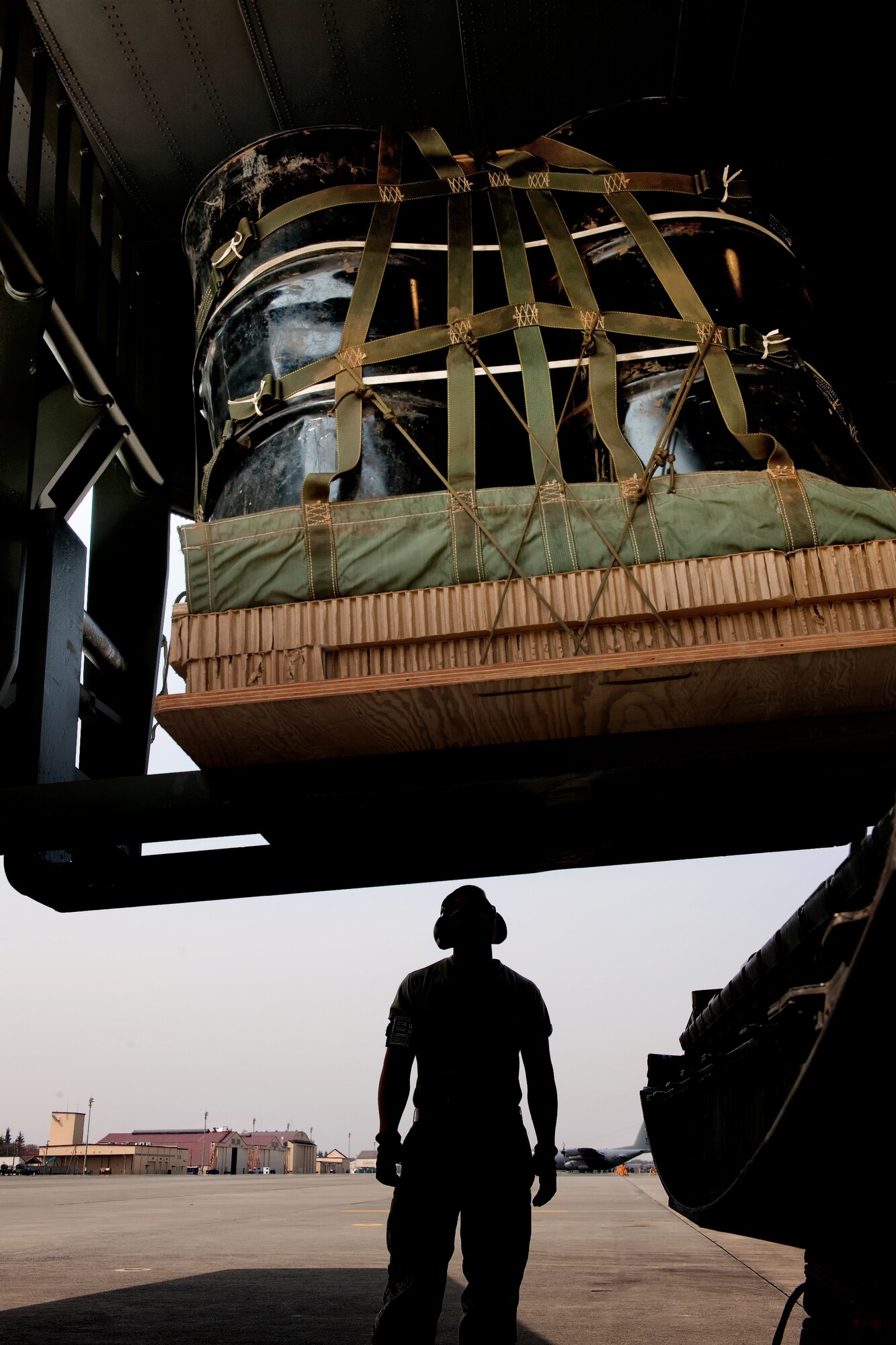 YOKOTA AIR BASE, Japan -- Airman 1st Class Marcus Ofoia-Stevens, 374th Logistics Readiness Squadron air transportation specialist, visually conforms the safety loading container delivery bundles onto a C-130 Hercules at Yokota Air Base, Japan, April 10, 2012. Airmen from the 374th LRS maintains and provides aerial equipments for use during training exercise and real-world deployment. (U.S. Air Force photo/Osakabe Yasuo)