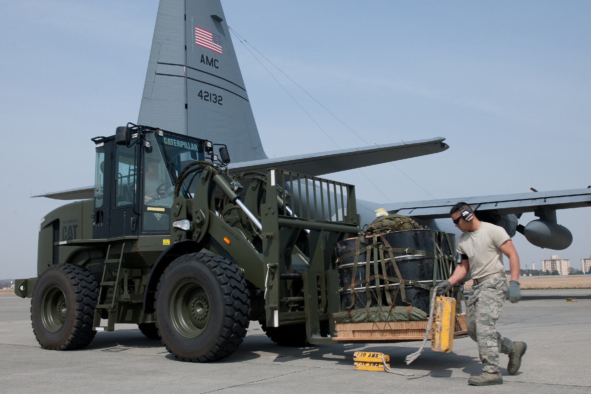 YOKOTA AIR BASE, Japan -- Airman 1st Class Marcus Ofoia-Stevens, 374th Logistics Readiness Squadron air transportation specialist, sets up a wheel chocks for parking 10K forklift at Yokota Air Base, Japan, April 10, 2012. Airmen from the 374th LRS maintains and provides aerial equipments for use during training exercise and real-world deployment. (U.S. Air Force photo/Osakabe Yasuo)