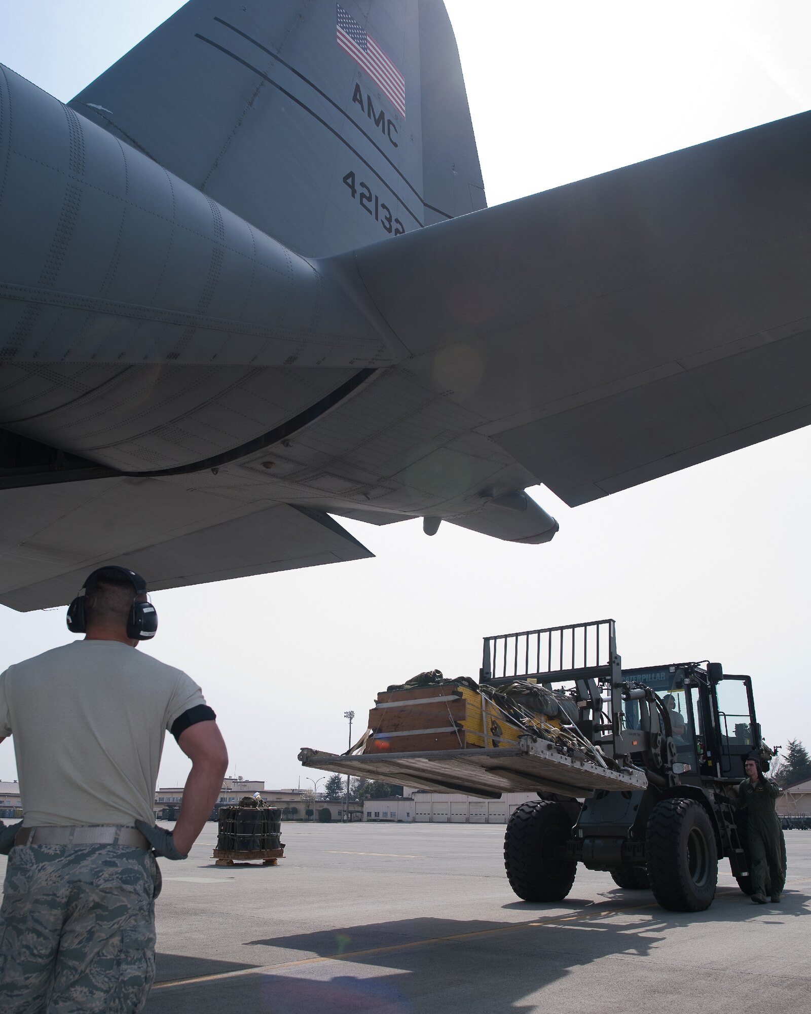 YOKOTA AIR BASE, Japan -- Members from the 374th Logistics Readiness Squadron combat mobility flight loading a container delivery bundles onto a C-130 Hercules at Yokota Air Base, Japan, April 10, 2012. Airmen from the 374th LRS maintains and provides aerial equipments for use during training exercise and real-world deployment. (U.S. Air Force photo/Osakabe Yasuo)