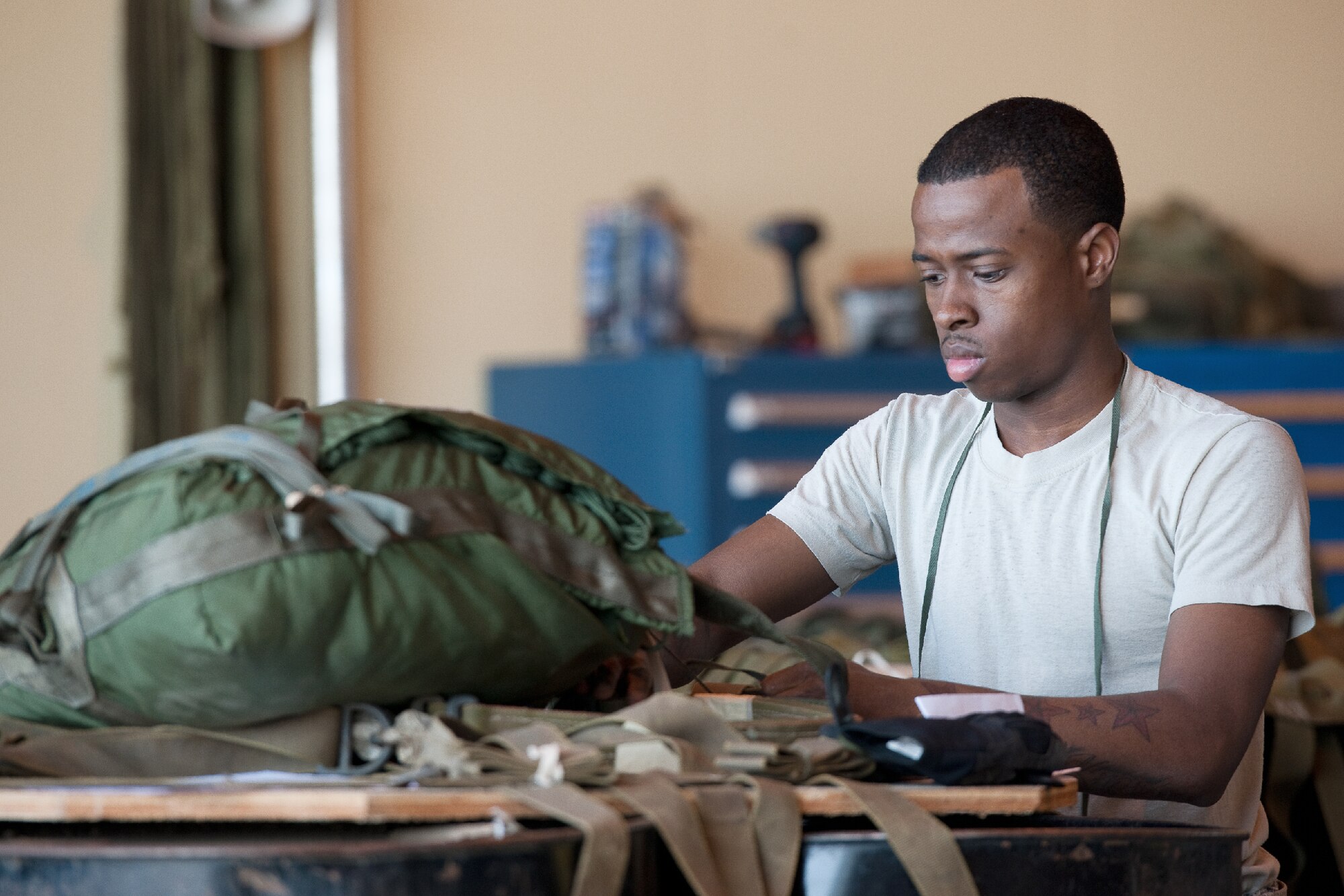 YOKOTA AIR BASE, Japan -- Senior Airman Jed Campbell, 374th Logistics Readiness Squadron air transportation specialist, inspects container delivery bundles at Yokota Air Base, Japan, April 10, 2012. The 374th LRS combat mobility flight maintains and provides aerial equipments for use during training exercise and real-world deployment. (U.S. Air Force photo/Osakabe Yasuo)