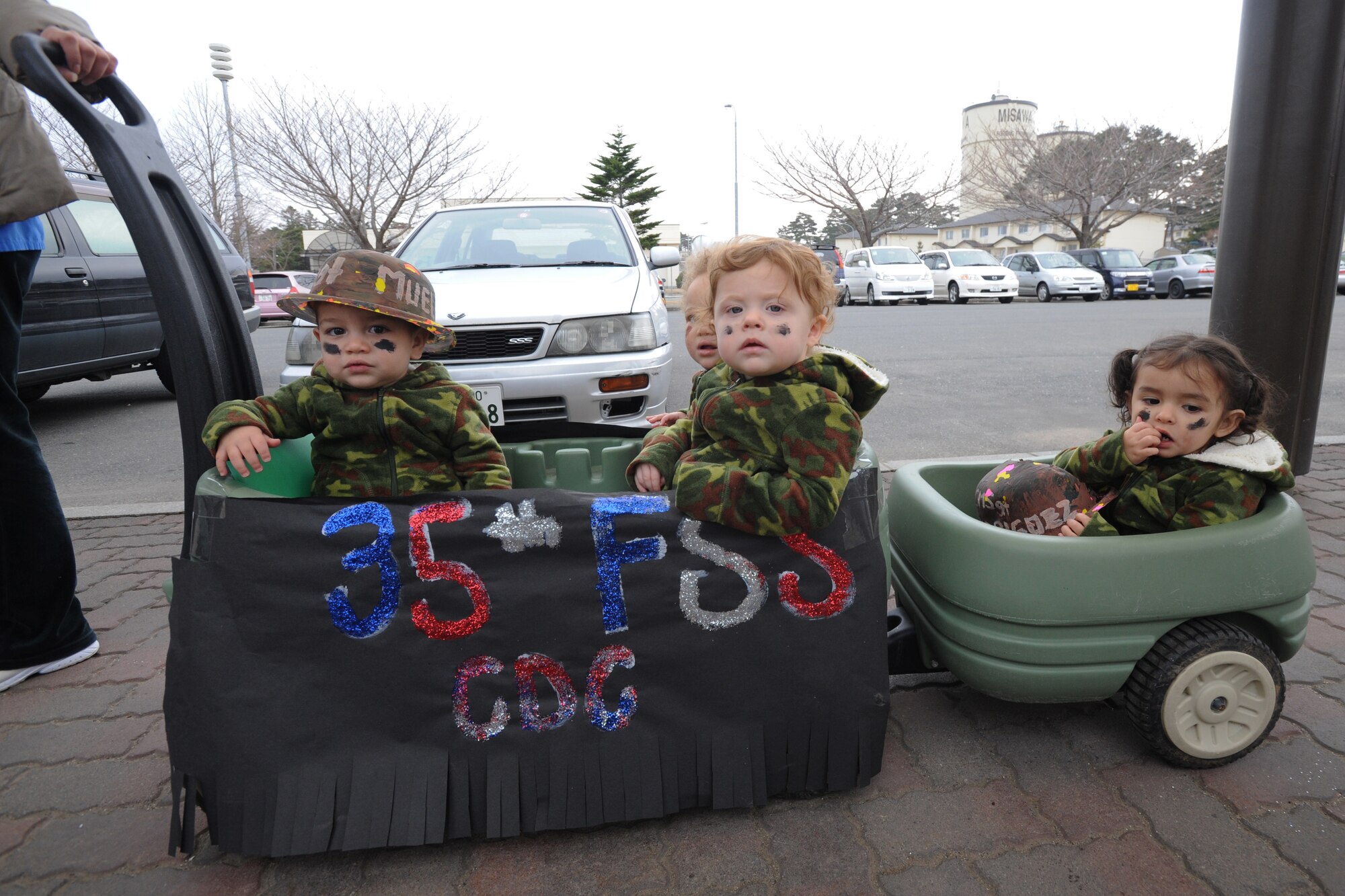 Children from the Yoiko Child Development Center sit in buggies while participating in the “March with Pride” fun walk at Misawa Air Base, Japan, April 11, 2012. While enjoying the Month of the Military Child fun walk, children are also given the chance to explore their local environment. (U.S. Air Force photo by Airman Kenna Jackson/Released)