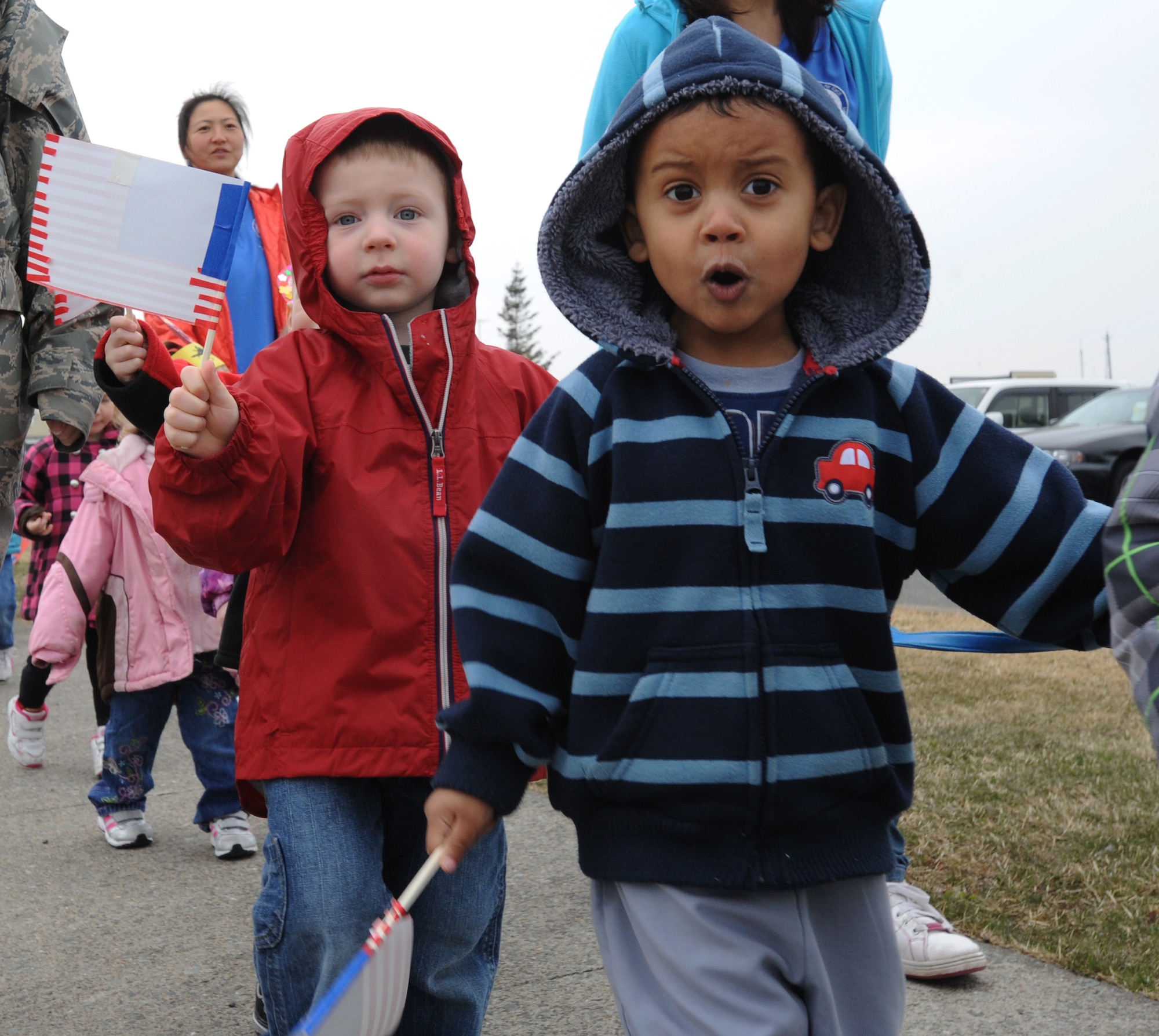 Children from the Yoiko Child Development Center wave paper flags during the “March with Pride” fun walk at Misawa Air Base, Japan, April 11, 2012. This is the second year the CDC has gathered the children to participate in the Month of the Military Child fun walk. (U.S. Air Force photo by Airman Kenna Jackson/Released)