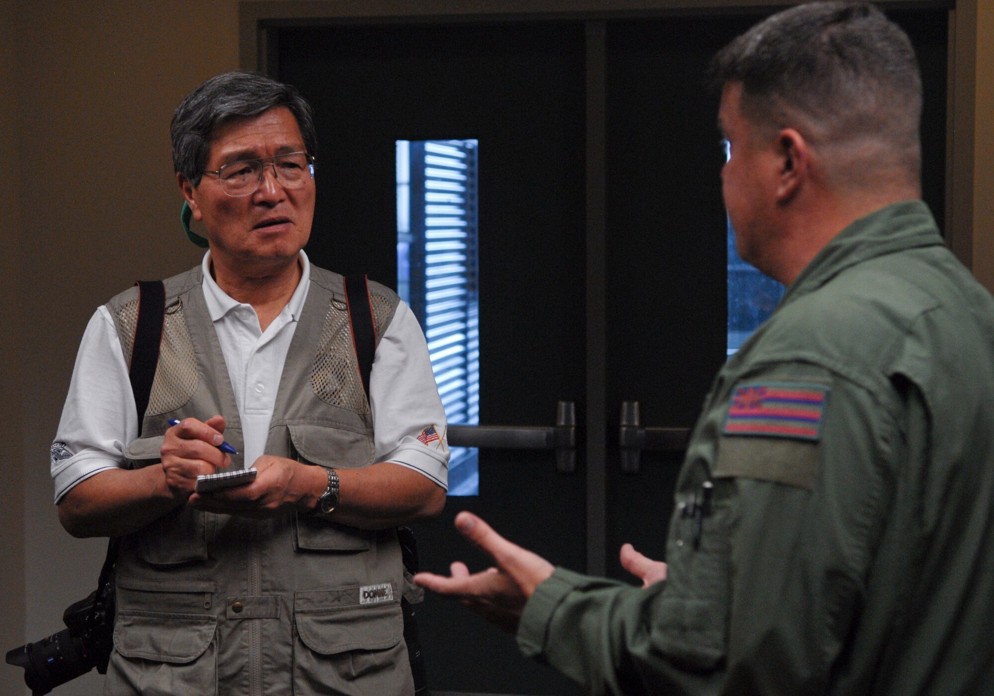 Susuma Tokunaga, reporter with Aireview Magazine (Japan) interviews a boom operator from the 96th Air Refueling Squadron on Joint Base Pearl Harbor-Hickam, HI, March 2. Tokunaga is documenting the 15th Wing, as part of the Pacific Air Forces, for a special edition of Aireview Magazine which focuses on the PACAF mission, as well as the relief that the 15th Wing provided during Operation Tomodachi. (U.S. Air Force photo/2nd Lt. Jessica Rowe)