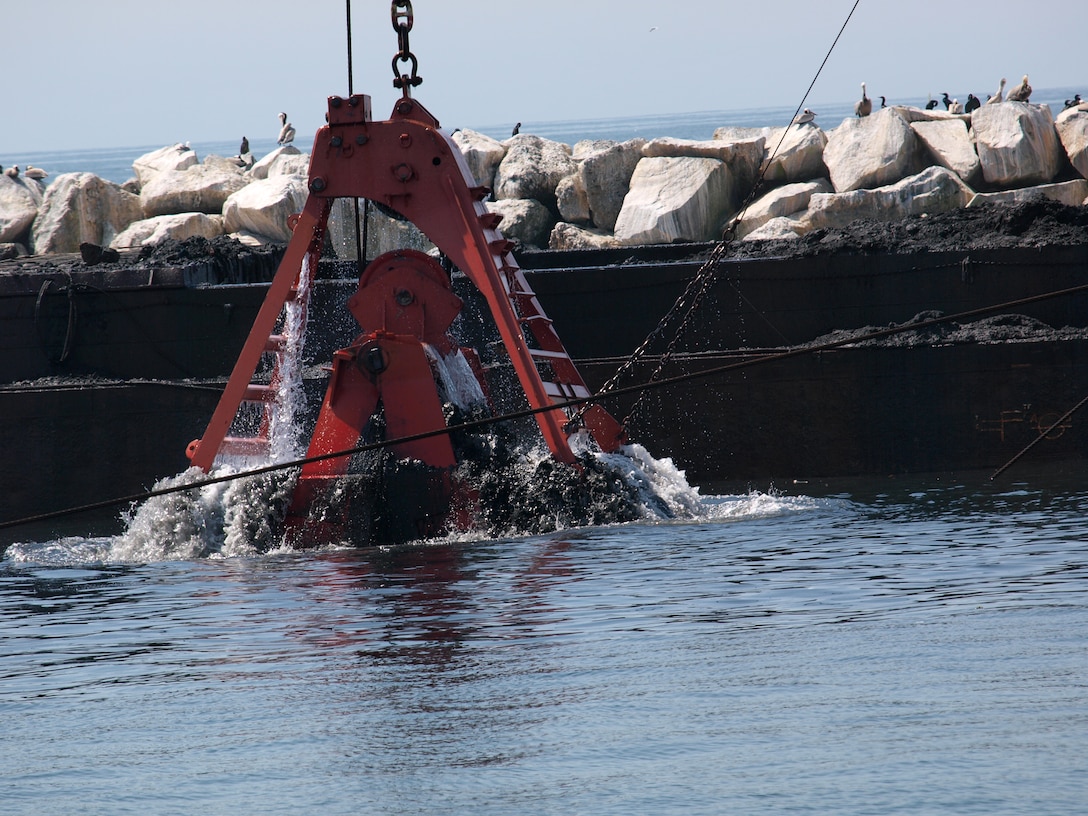 Dutra Dredging Company of San Rafael, Calif., uses the clamshell dredge Paula Lee to place about 520,000 cubic yards of the sand into barges that tugs will then transport to the Port of Long Beach for its Middle Harbor Redevelopment Project. The U.S. Army Corps of Engineers began a $13 million dredging project April 5 that will remove up to one million cubic yards of accumulated sand from the entrance channel to Marina del Rey Harbor. 