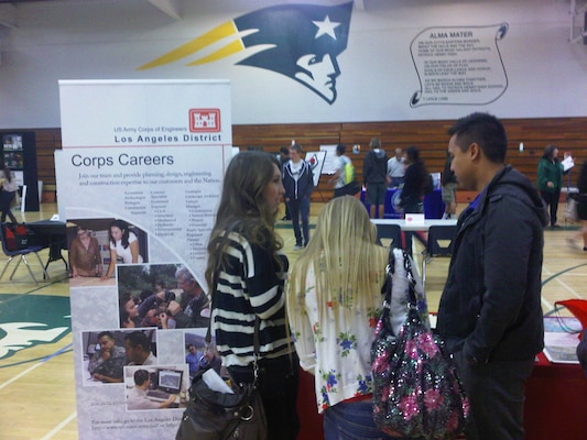 Jonathan Guerrero, a Corps study manager, answers students' questions during "If the Shoe Fits," an annual career day held March 30, at Patrick Henry High School in San Diego.