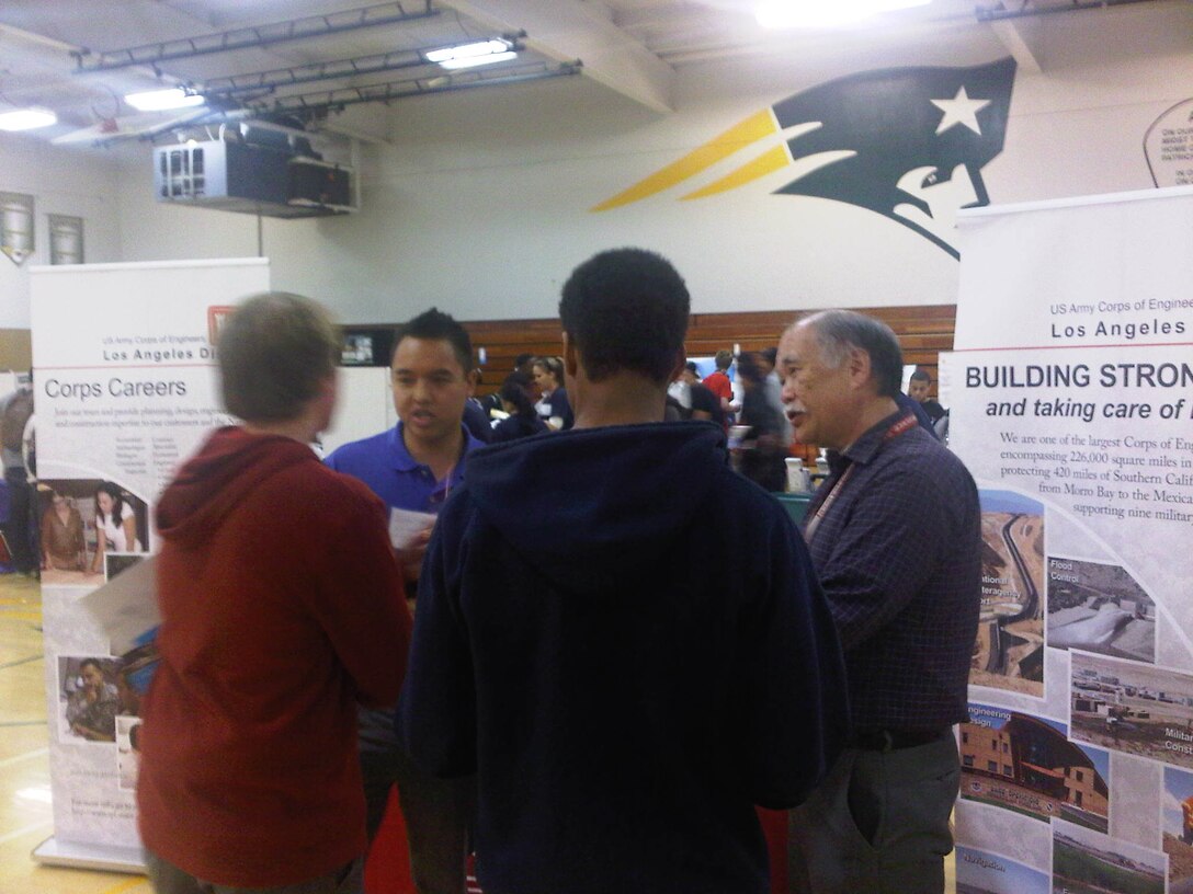Los Angeles District project manager Ed Louie (right) and planner Jonathan Guerrero (second from left) discuss Army Corps of Engineers career opportunities with students at "If the Shoe Fits" career day March 30, at Patrick Henry High School in San Diego. Nearly 1,800 students in the 9th through 12th grades attended the event that featured representatives from 15 different Southern California industries.
