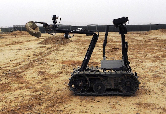 AFGHANISTAN — A robot at the SPC Jeremy J. Loveless Blow-in-Place Engineer Training Facility at Kandahar Airfield demonstrates its remarkable dexterity by picking up the photographer's cap on March 24, 2012.