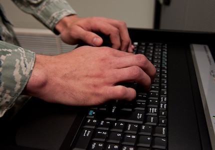 Airman 1st Class Brock Metscher, 28th Communications Squadron cyber systems operations operator, inputs information into a server computer at Ellsworth Air Force Base, S.D., April 4, 2012. These servers control the computer networks on base and are a key part of many operations. (U.S. Air Force photo by Airman 1st Class Kate Thornton/Released)