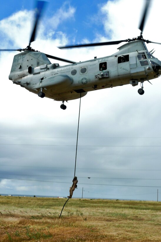 A Marine from the 15th Marine Expeditionary Unit’s Maritime Raid Force fast-ropes from a CH-46E Sea Knight during a fast-roping exercise, here, April 11. The MRF's primary role is to carry out raids against maritime objectives including gas and oil platforms, ships and targets on shore. This was the first time the MRF was able to practice their unique skill sets as a cohesive unit.