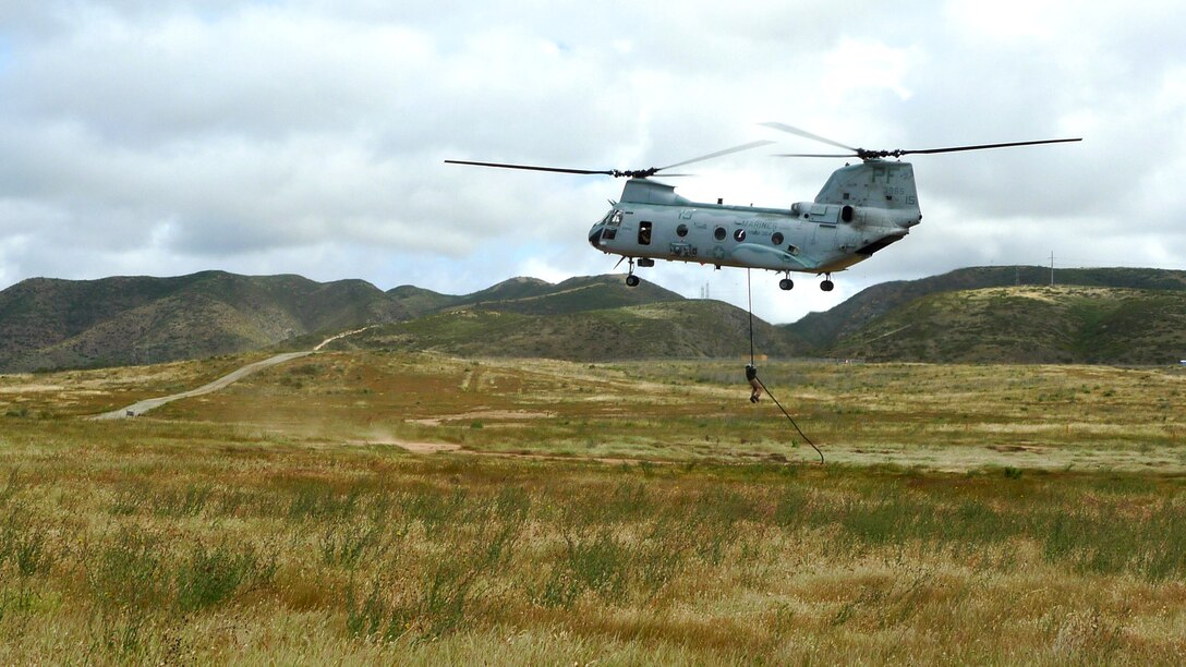 A Marine from the 15th Marine Expeditionary Unit’s Maritime Raid Force fast-ropes from a CH-46E Sea Knight during a fast-roping exercise, here, April 11. The MRF's primary role is to carry out raids against maritime objectives including gas and oil platforms, ships and targets on shore. This was the first time the MRF was able to practice their unique skill sets as a cohesive unit. (U.S. Marine Corps photo by Lance Cpl. Timothy Childers)::r::::n::