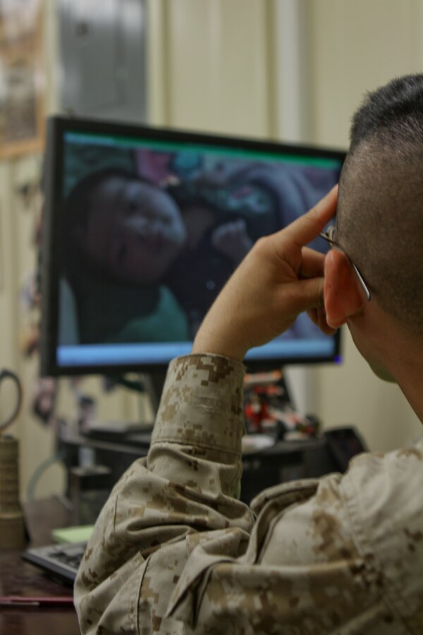Col. Christopher Michelsen, right, and Master Sgt. Freddie Hill, left, uncase Marine Corps Logistics Command (Forward) colors in Afghanistan for the first time during a ceremony at Camp Leatherneck Afghanistan, April 5.