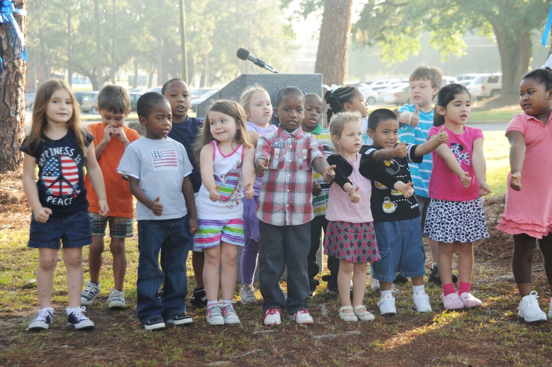 Children with the Child Development Center sing during the Child Abuse Awareness and Prevention Proclamation Ceremony in front of Marine and Family Services, here, April 5.