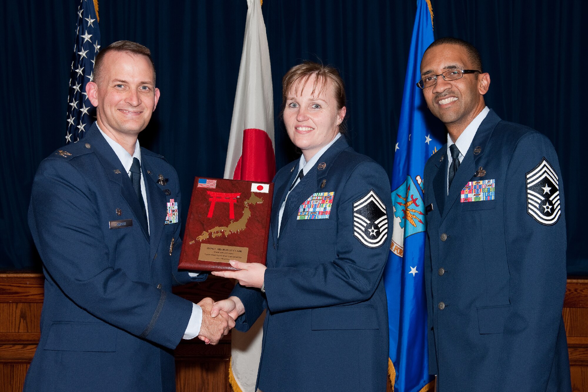 YOKOTA AIR BASE, Japan -- Senior Master Sgt. Sharon St.Clair, 374th Medical Support Squadron, receives the Senior NCO of the Quarter plaque during Team Yokota's First Quarterly Awards ceremony at Yokota Air Base, Japan, April 12, 2012. Col. Bill Knight, 374th Airlift Wing commander, and Command Chief Master Sgt. Ronald Draper, 374th AW, present the award to St.Clair during the ceremony. (U.S. Air Force photo/Osakabe Yasuo)