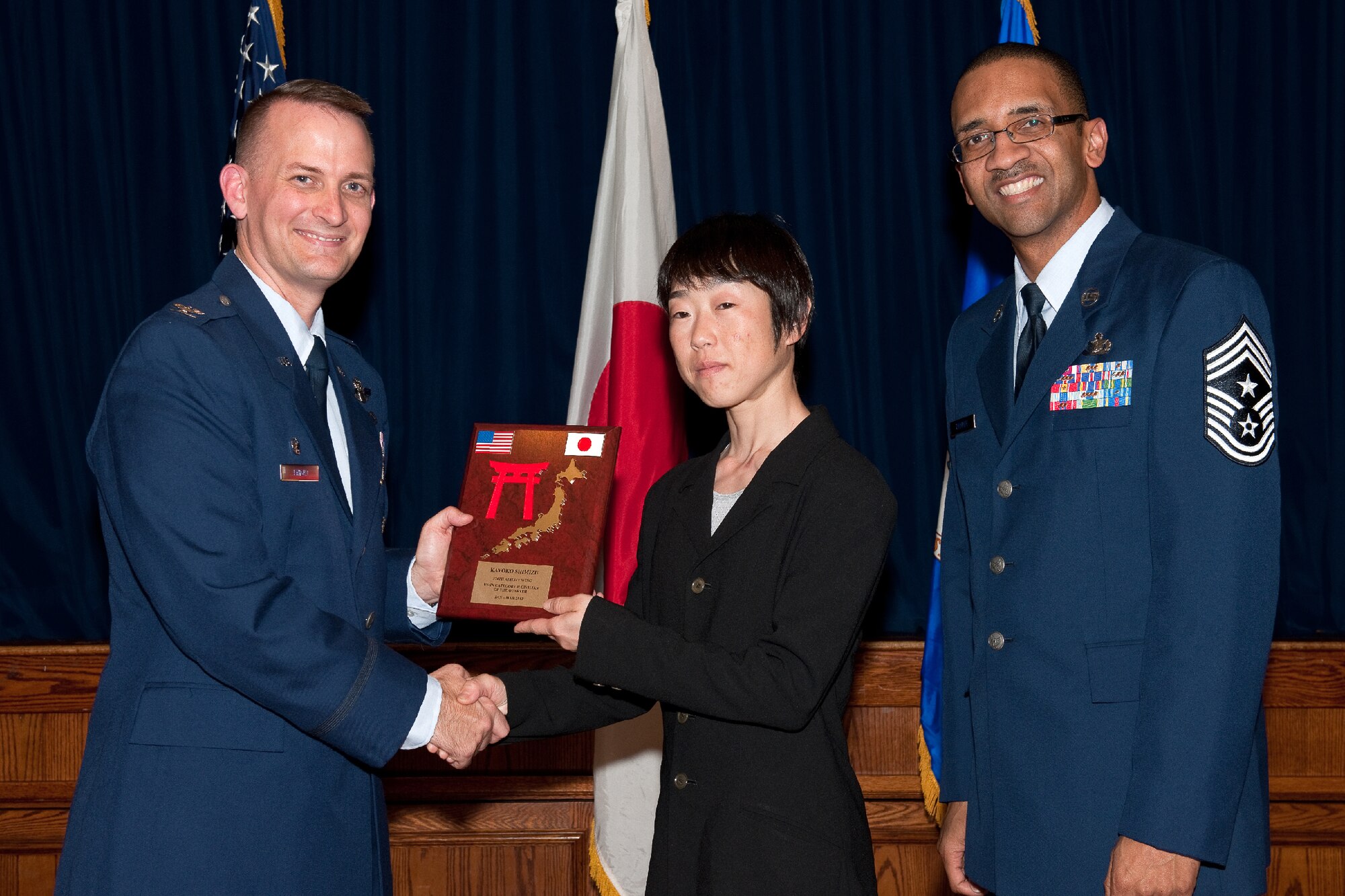 YOKOTA AIR BASE, Japan -- Kayoko Shimizu, 374th Civil Engineer Squadron, receives the US/JN category II civilian of the Quarter plaque during Team Yokota's First Quarterly Awards ceremony at Yokota Air Base, Japan, April 12, 2012. Col. Bill Knight, 374th Airlift Wing commander, and Command Chief Master Sgt. Ronald Draper, 374th AW, present the award to Shimizu during the ceremony. (U.S. Air Force photo/Osakabe Yasuo)