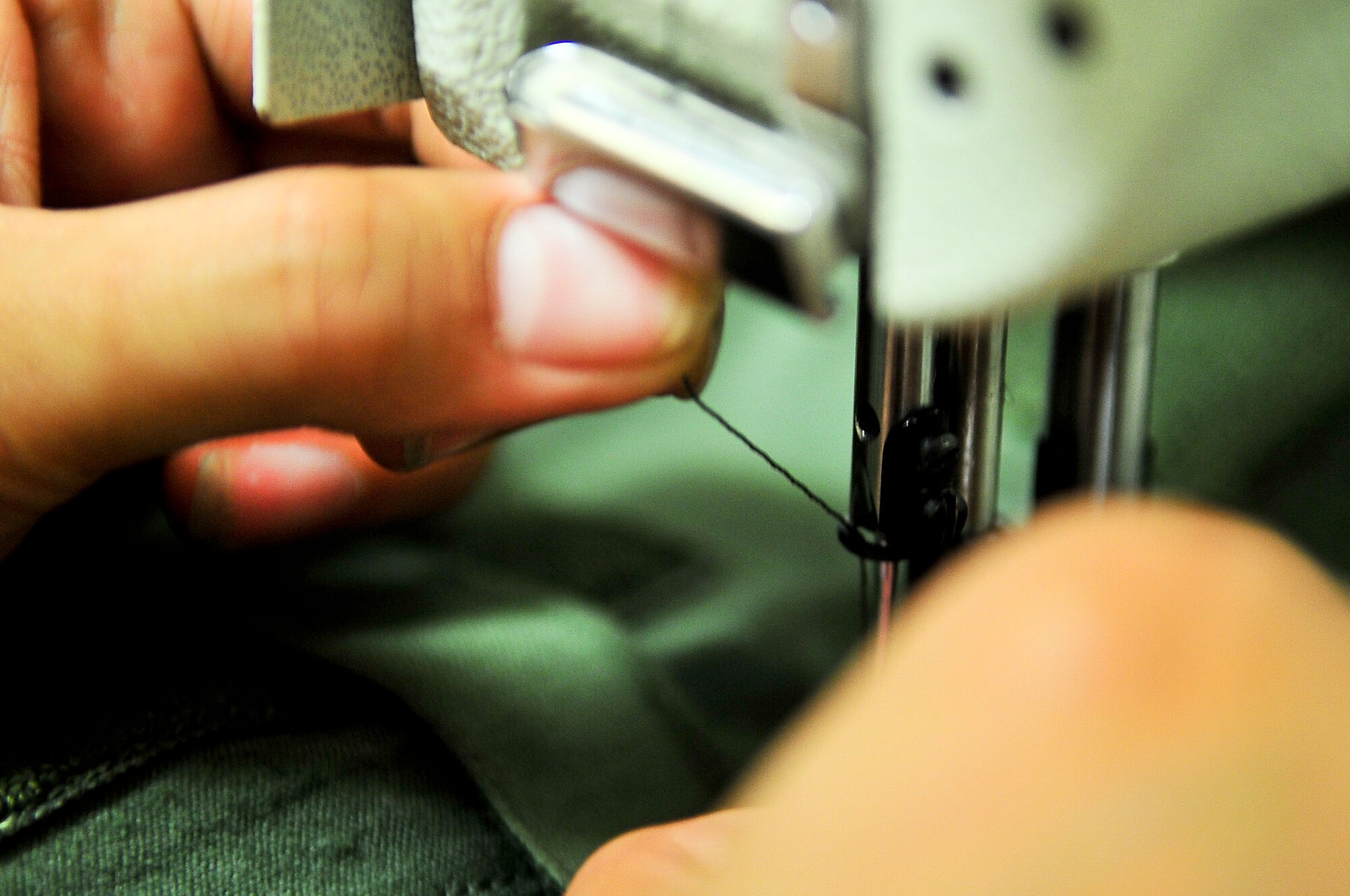 Staff Sgt. Chelsie Aiona Aka, 51st Operations Support Squadron aircrew flight equipment journeyman, sews a harness back onto a G-suit April 10, 2012. Aiona Aka is able to do minor repairs to G-suits such as sewing on patches and map straps. (U.S. Air Force photo/Senior Airman Adam Grant)
